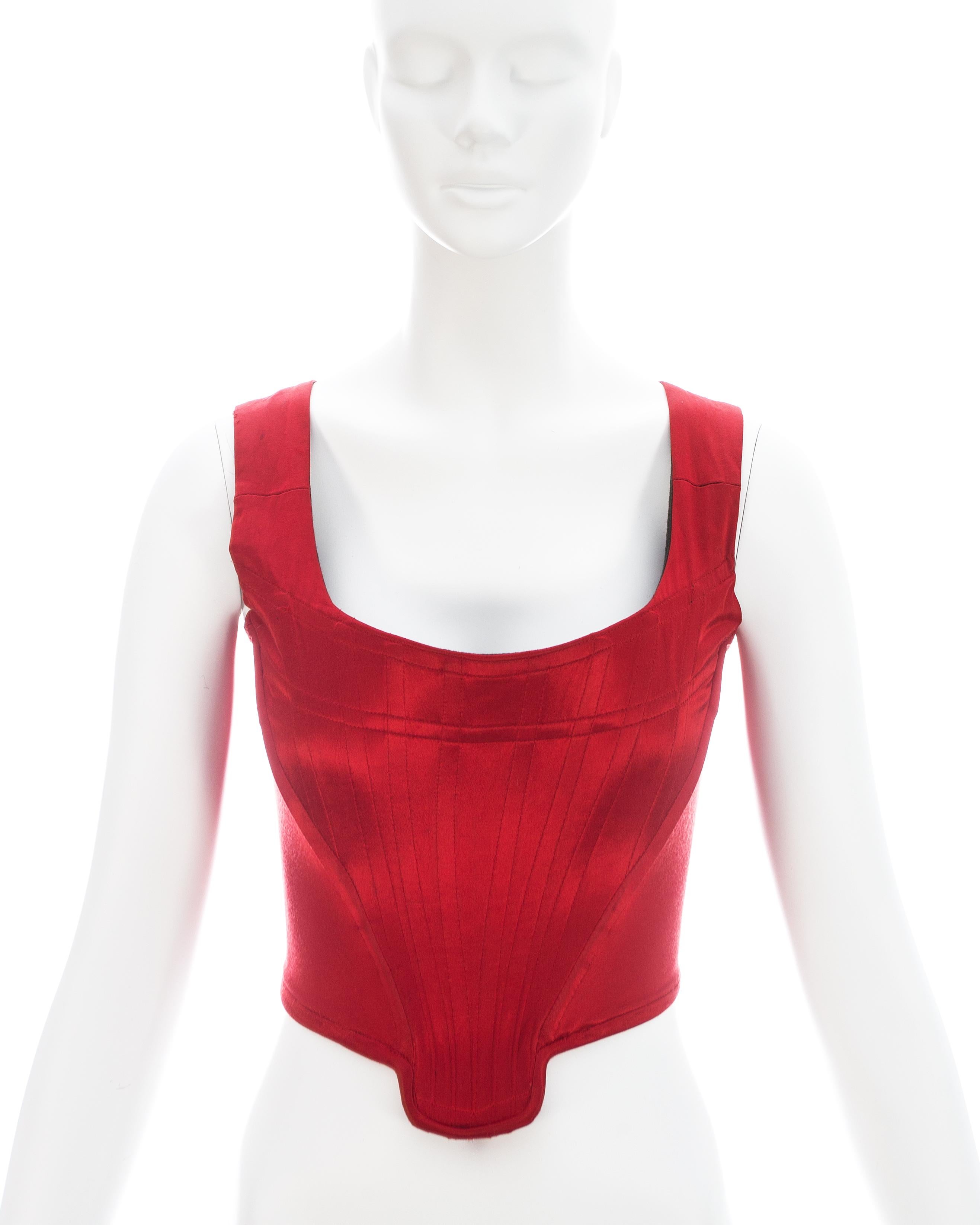 Vivienne Westwood; Red satin corset with internal boning on bodice designed to cinch the waist and push the breasts up 

Fall-Winter 1991