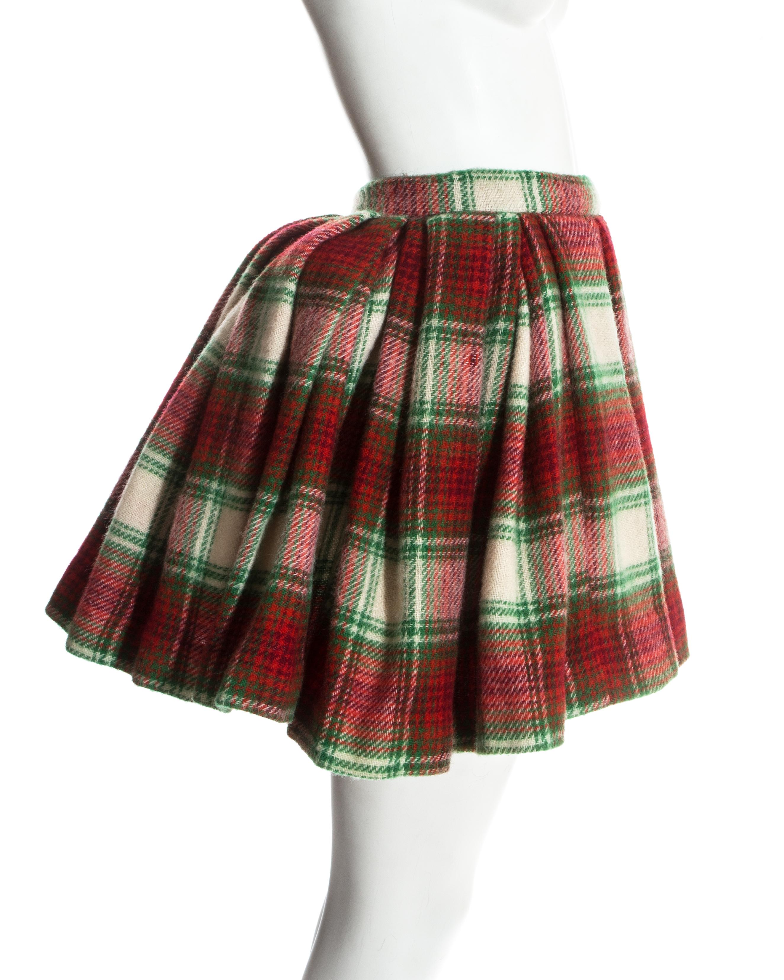Vivienne Westwood red tartan wool pleated skirt. Inside are the four original safety pin attached padded balls which were used in the show to exaggerated the rear; as a bustle would do. 

Time Machine, Fall-Winter 1988