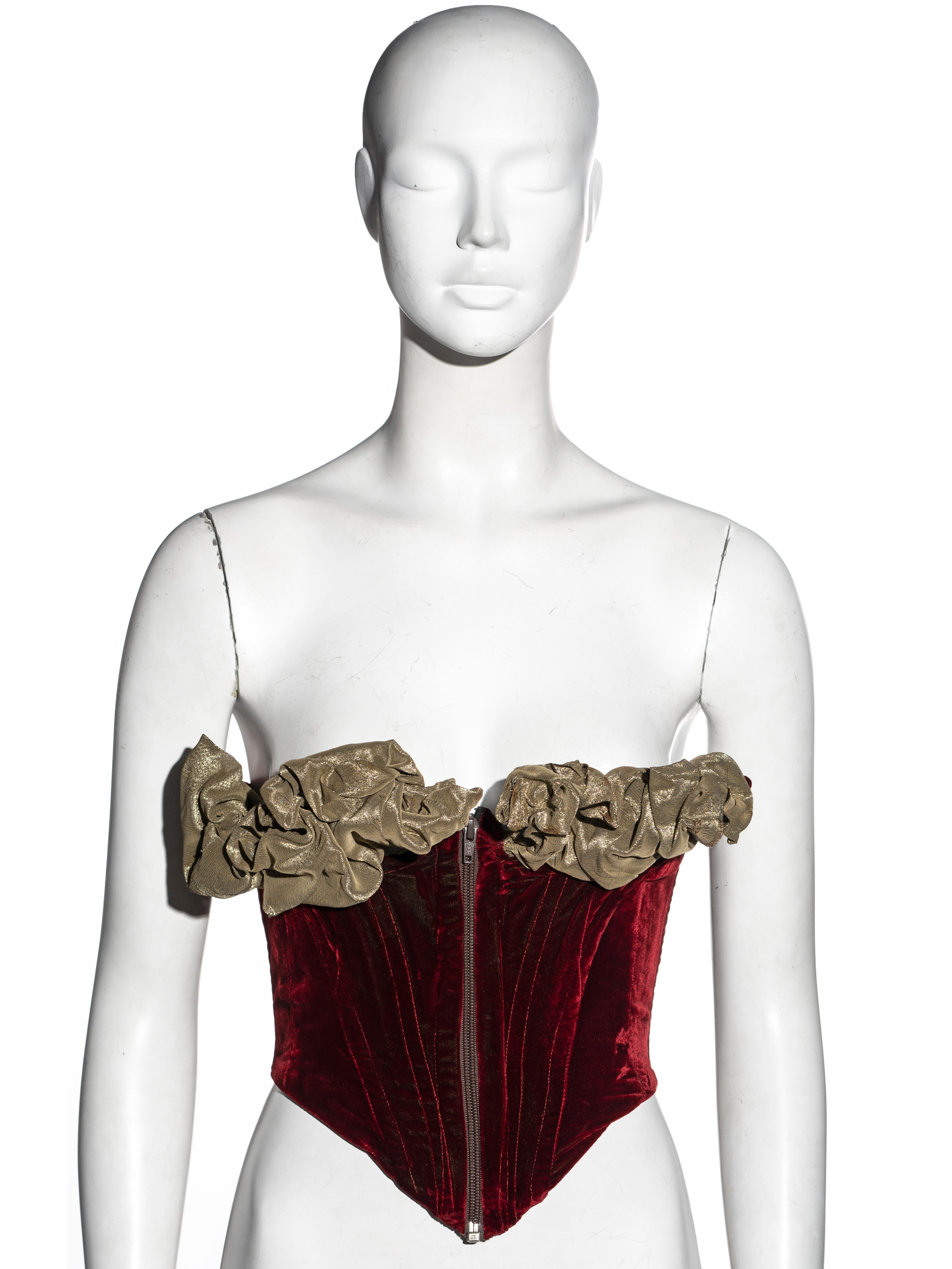 ▪ Vivienne Westwood strapless corset
▪ Museum piece
▪ Red velvet 
▪ Olive lamé bra with wired piping 
▪ Center-front zipper
▪ Size XS/S
▪ Fall-Winter 1989
▪ Made in England