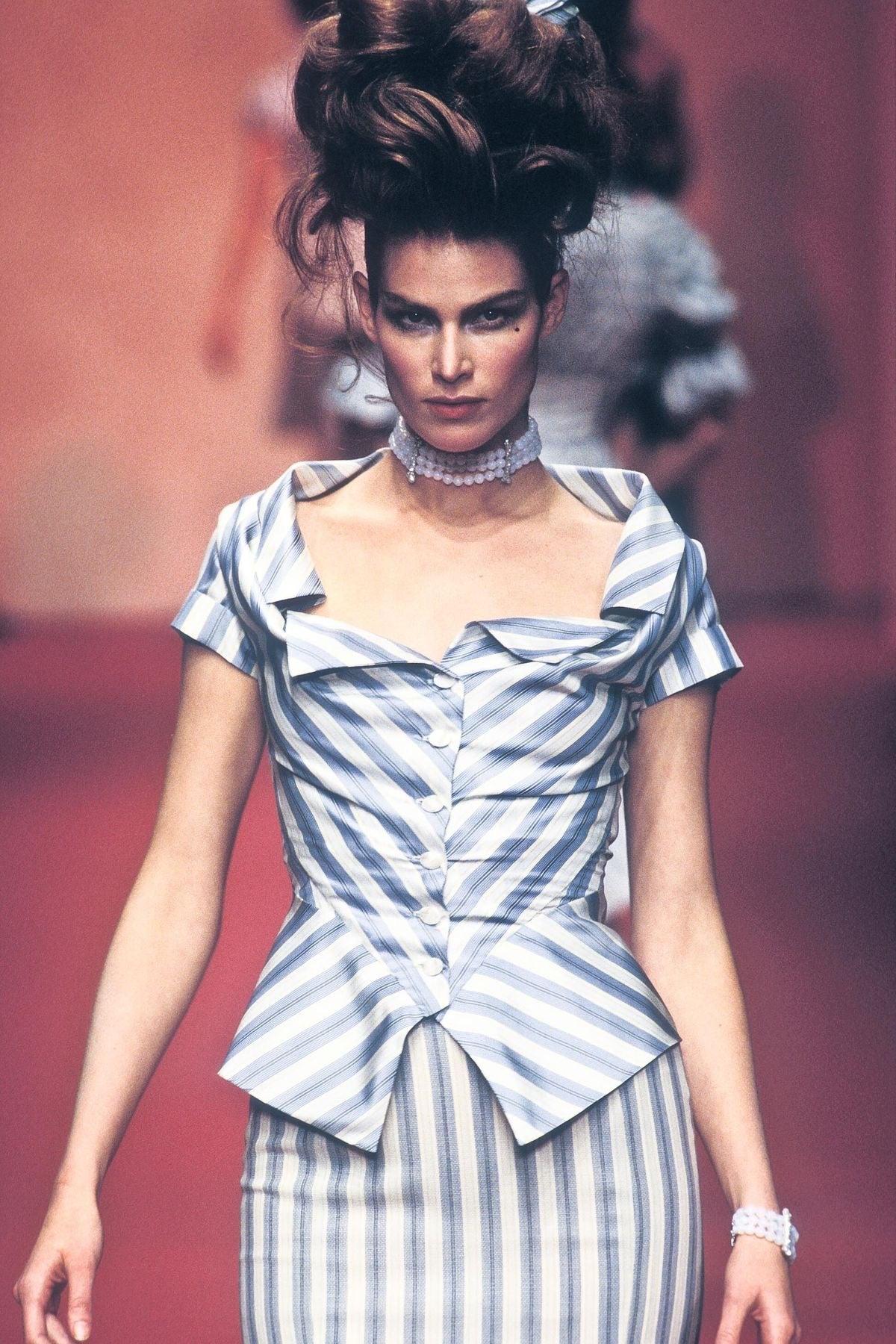 Dating to the S/S 1997 'Vive La Bagatelle'  collection, this beautiful Vivienne Westwood top was worn on the runway by model Meghan Douglas. Made of 100% silk in a blue & white striped print, it features a draped & folded neckline, nipped in waist