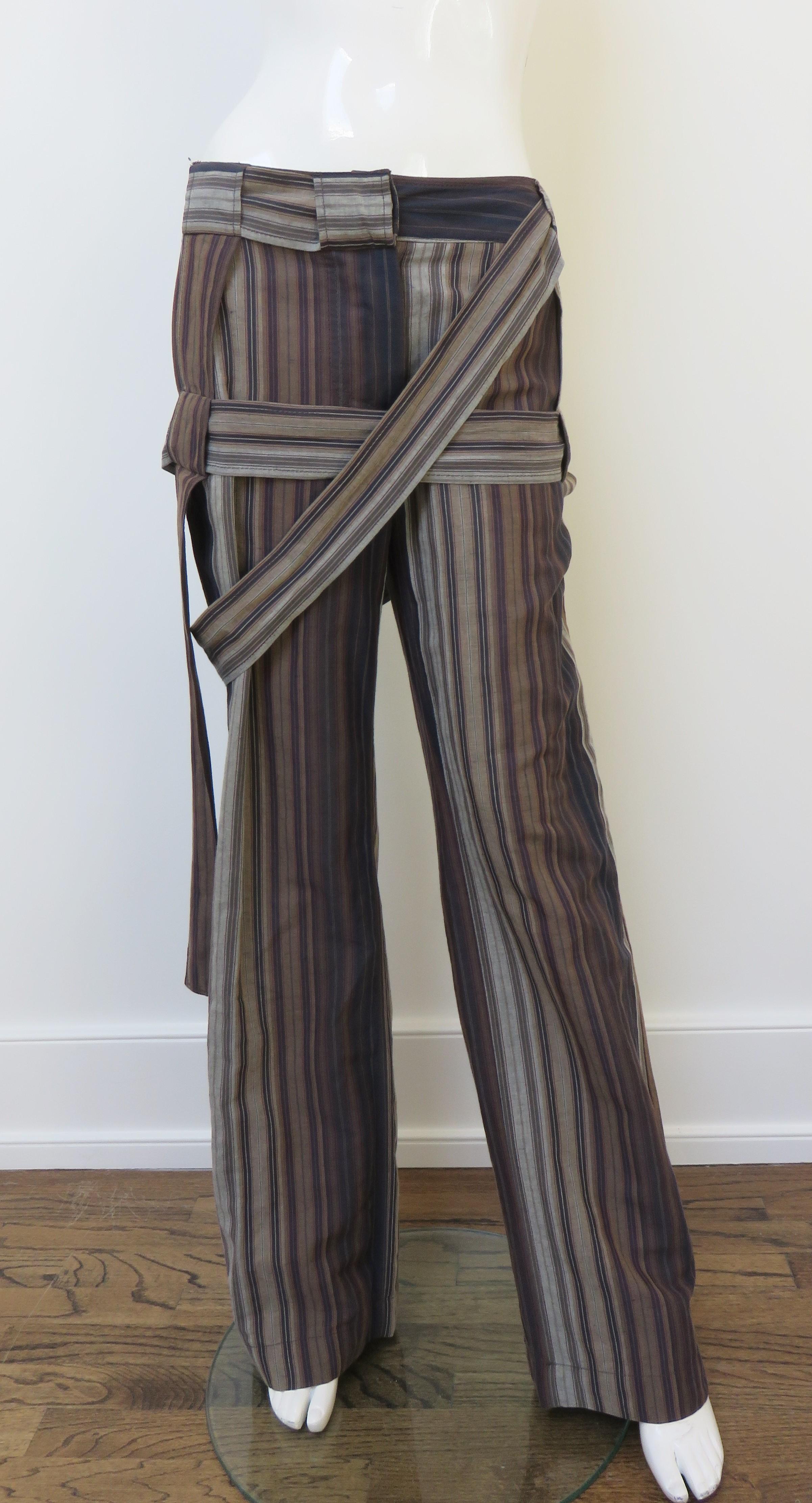 A fabulous pair of linen cotton blend pant from the late, great Vivienne Westwood in brown, grey, and black variegated vertical stripes. They are mid rise with a waistband, front button fly, back patch pocket, side seam pockets and straight legs. A