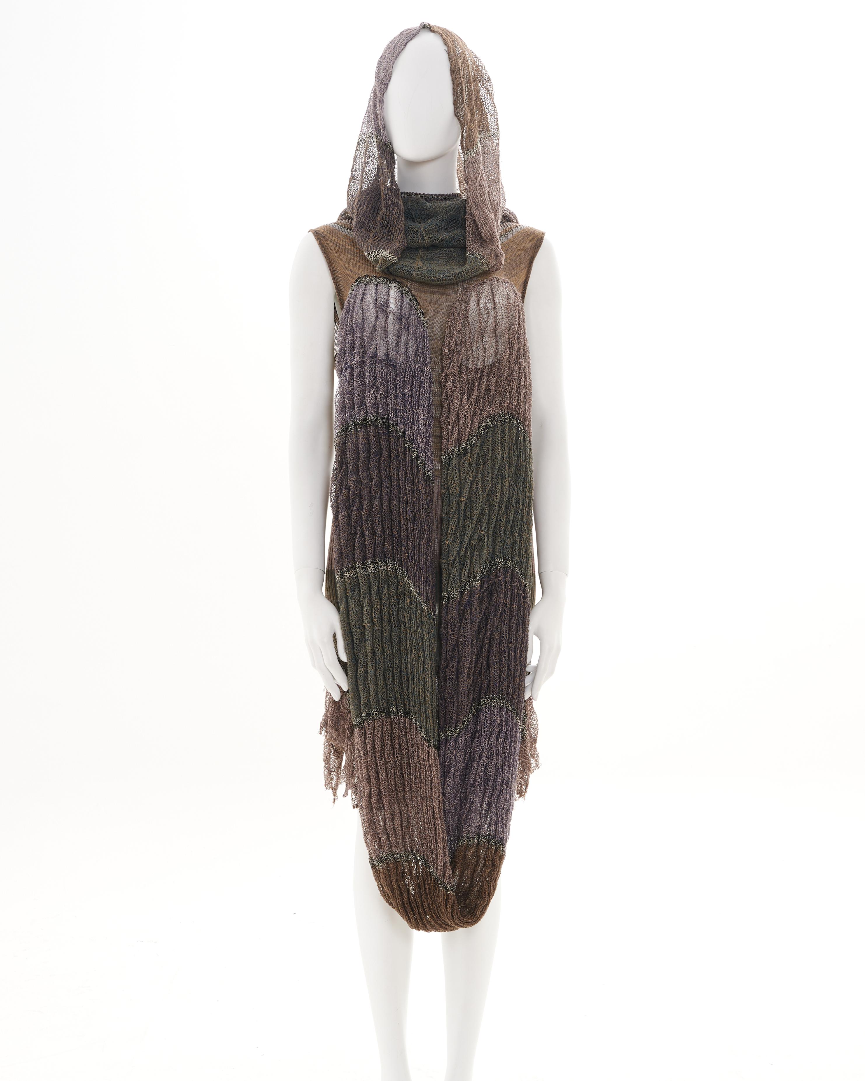 - Designed by Vivienne Westwood 
- Sold by Skof.Archive
- Spring-Summer 2005 Runway 
- Rib-knit skirt and collar 
- Above the knee length 
- Open-knit tubular scarf attached at the breasts
- Extra-collar which doubled as a hood 
- Distressed finish