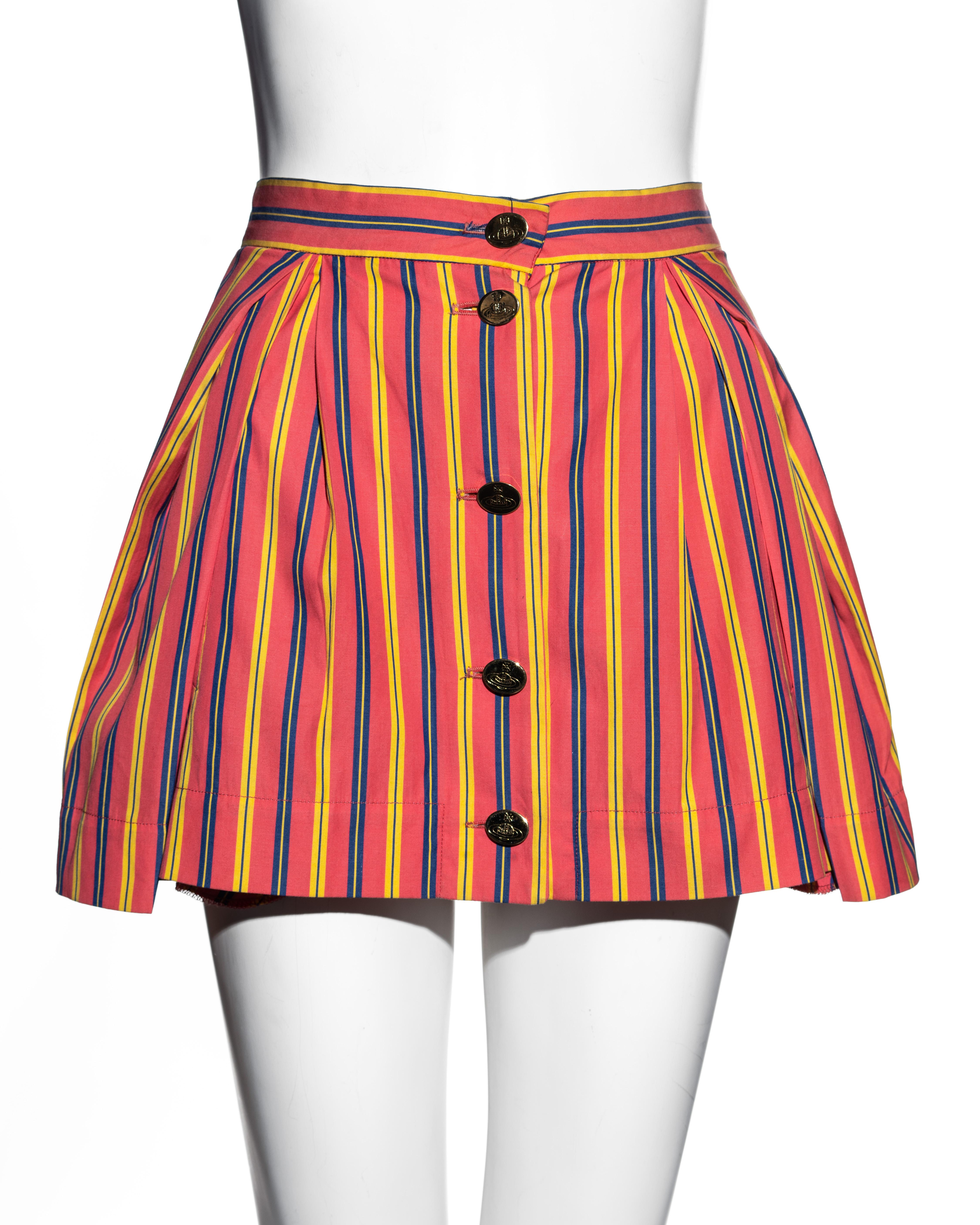 ▪ Vivienne Westwood salmon pink cotton pleated mini skirt 
▪ Yellow and blue stripes with salmon pink ground 
▪ Gold orb etched buttons 
▪ Labelled UK '12' but fits smaller 
▪ Spring-Summer 1993