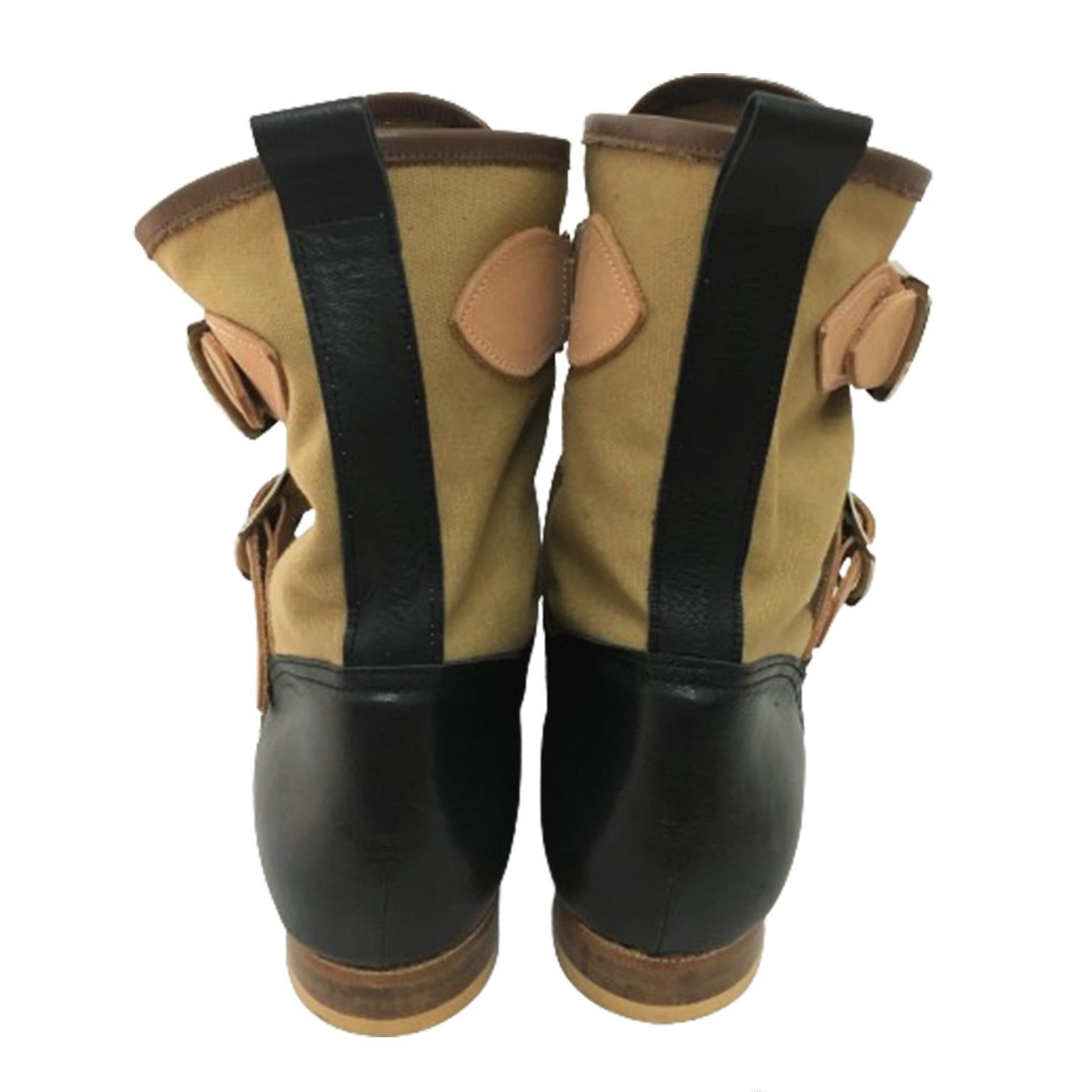 First seen in Westwood Mclaren 1976 'Seditionaries' collection, the Seditionaries boots are made in England from khaki canvas, black leather and feature buckle fastenings in raw tan leather. 
Concealed lace-up fastening (Comes with extra shoelace in