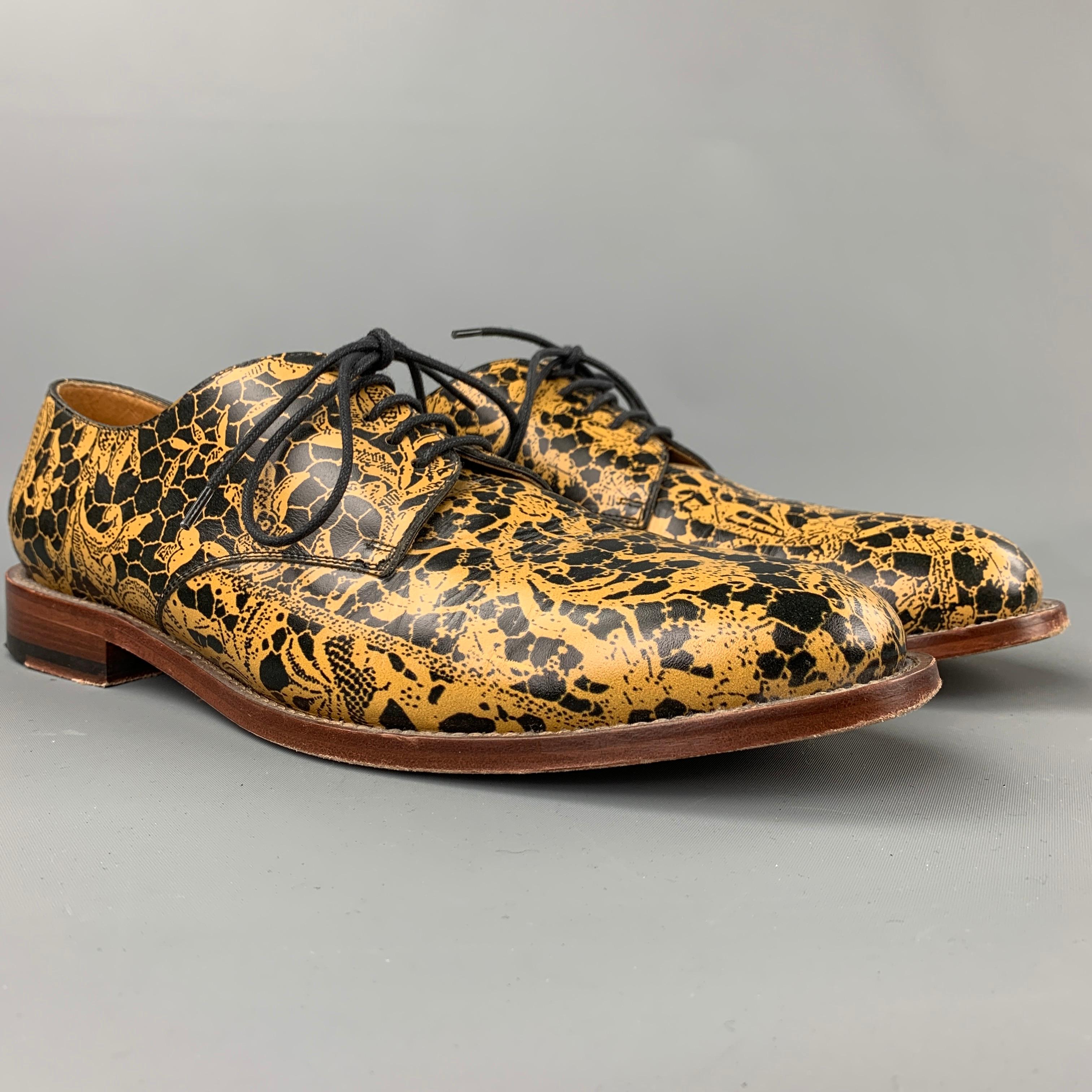 VIVIENNE WESTWOOD shoes comes in a black & yellow abstract leather featuring a cap toe, wooden sole, and a lace up closure. Made in Italy.

Very Good Pre-Owned Condition.
Marked: 45

Outsole: 12.5 in. x 4.5 in. 