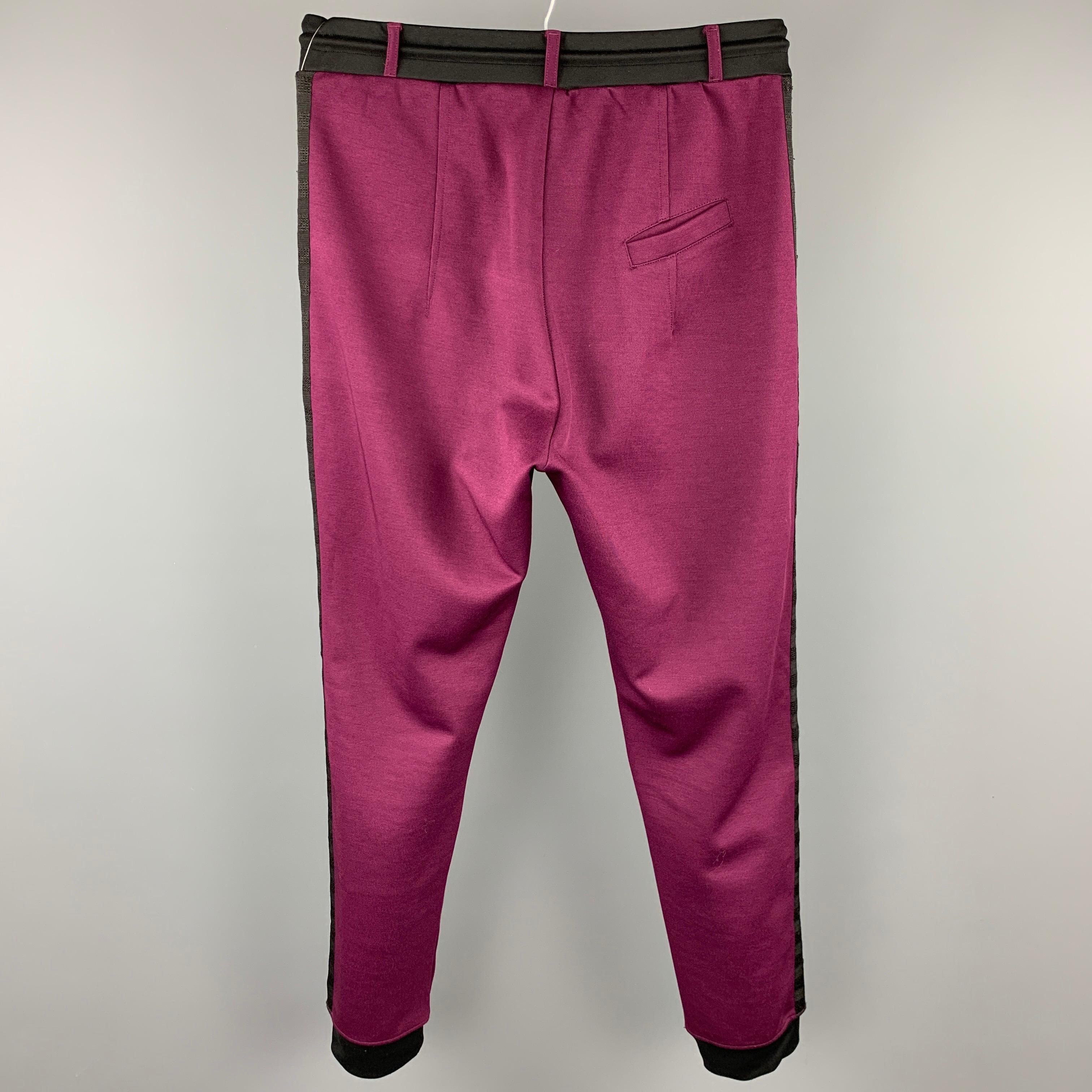 VIVIENNE WESTWOOD MAN casual pants comes in a purple & black color block cotton / polyester featuring a jogger style, elastic waistband, slit pockets, button fly, and a drawstring. 

Very Good Pre-Owned Condition.
Marked: L

Measurements:

Waist: 32