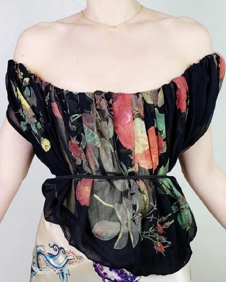 One of the rarest vintage Vivienne Westwood corsets - this stunning number with the infamous rose print from Spring 1994 Café Society collection has a very interesting unique structure.

The actual corset is made out of nude mesh base with stretchy