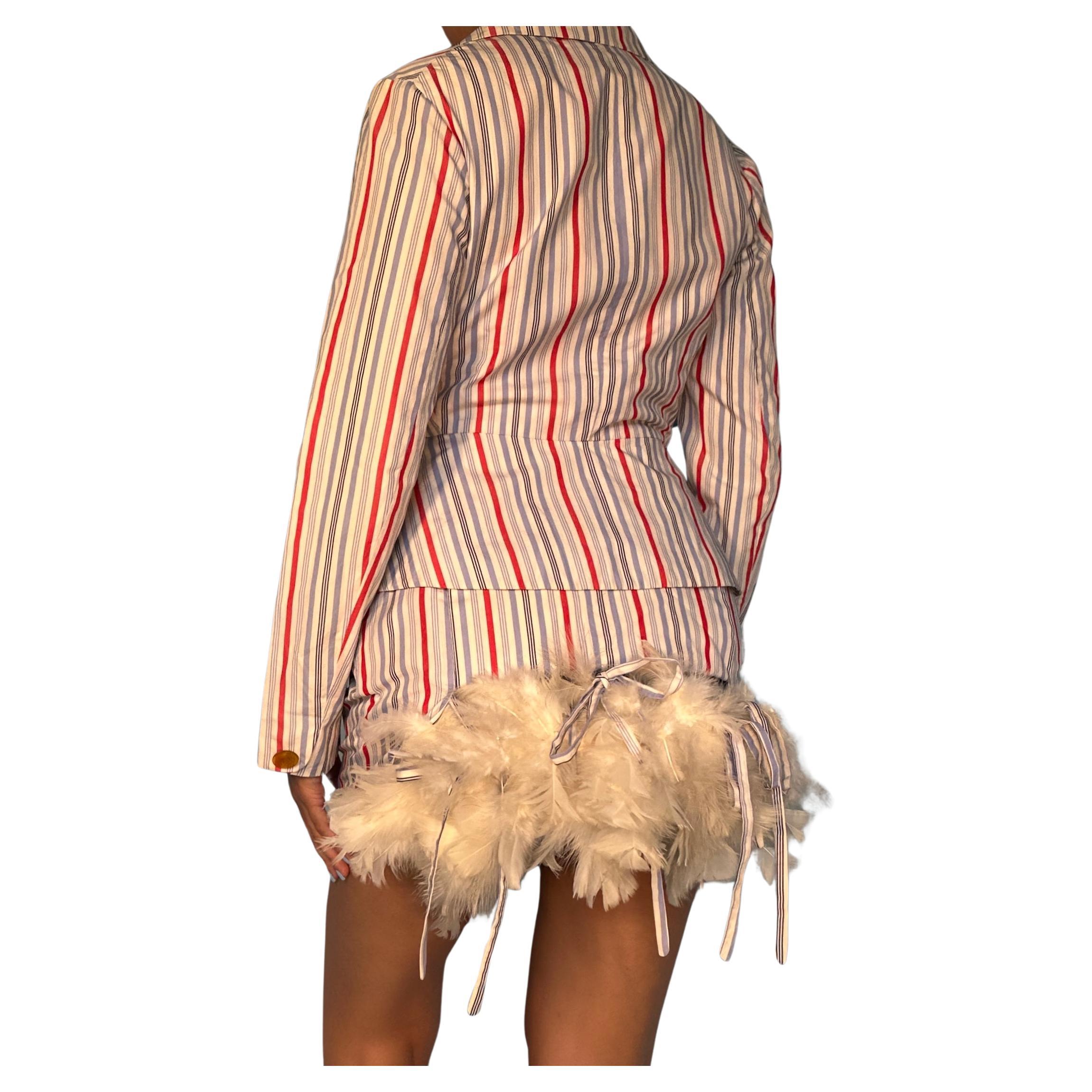 Vintage Vivienne Westwood

Spring 1994 “Cafe Society” collection - seen on the runway

Red, white and blue striped skirt & jacket suit set

Feather bustle detail on skirt 

Detachable feather boa, held in with tie ups 

Fitted blazer jacket 

High