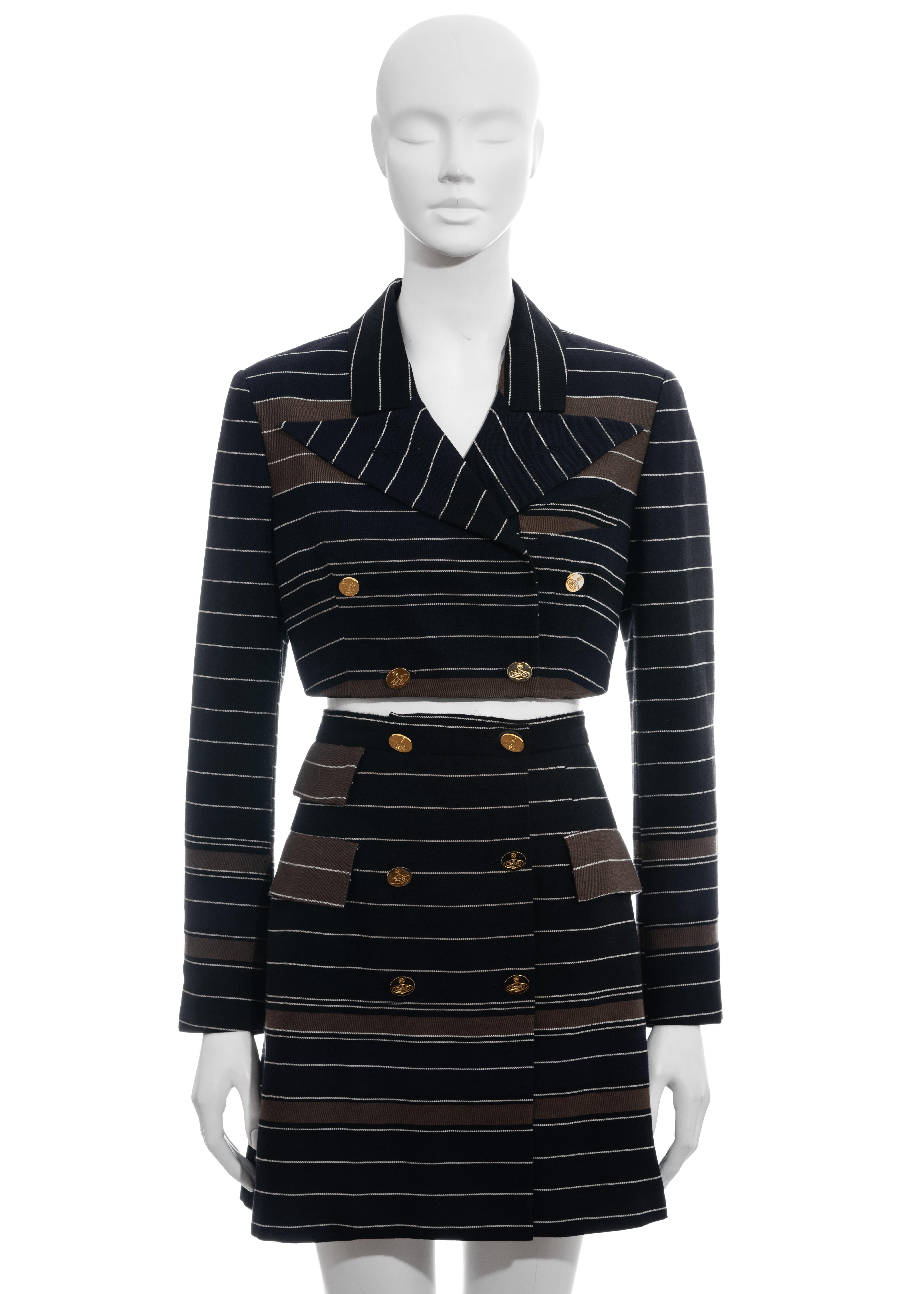 ▪ Vivienne Westwood skirt suit
▪ 69% Wool, 31% Cotton
▪ Black, Navy, Brown and White stripes 
▪ Doubled breasted cropped blazer jacket 
▪ High waist mini wrap skirt with built-in corset
▪ Gold orb etched buttons 
▪ IT 42 - FR 38 - UK 10 - US 6
▪
