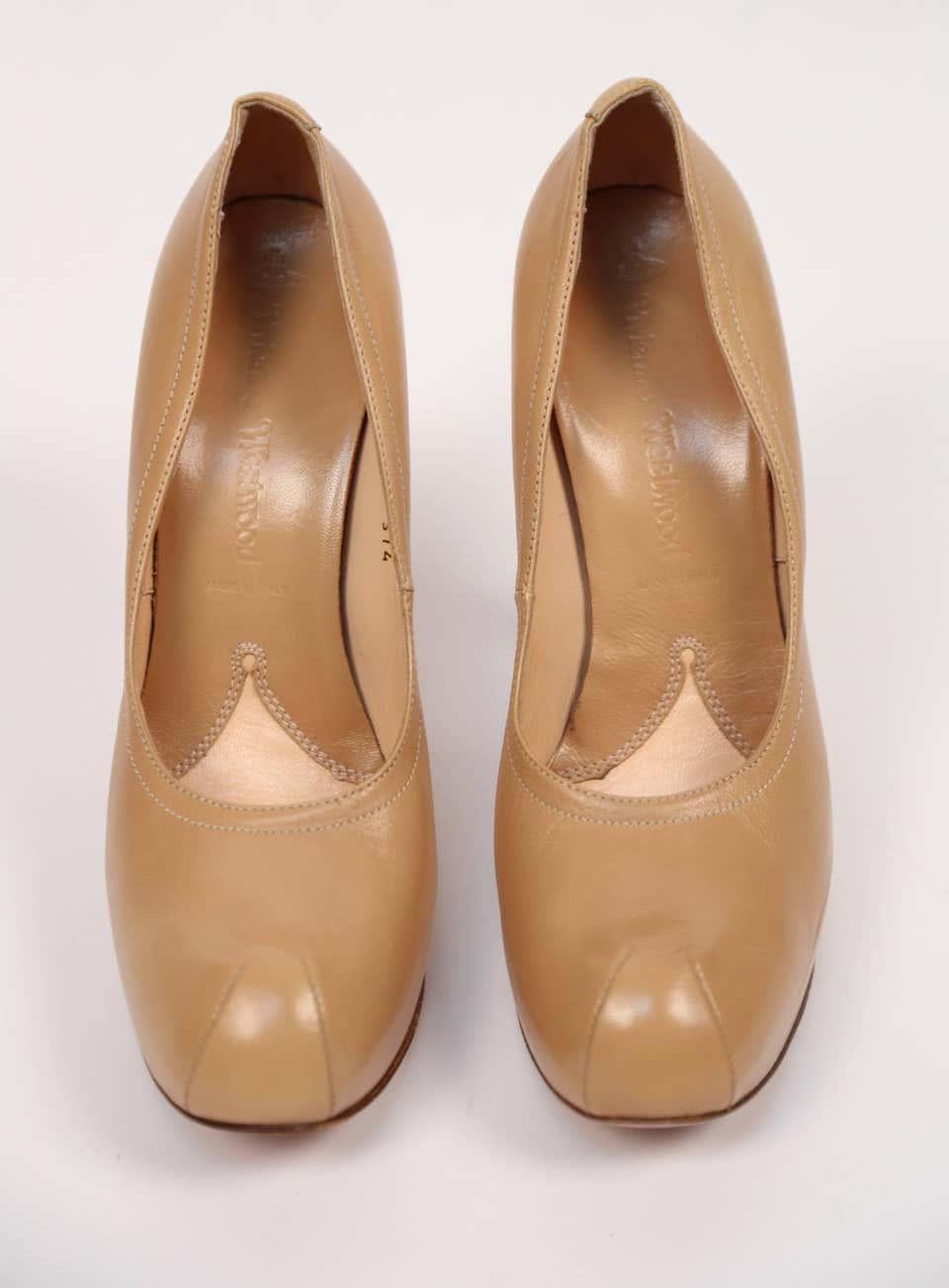 Towering tan leather platform heels from Vivienne Westwood dating to the early 2000's. European size 41. Approximate measurements: insoles just over 10.75