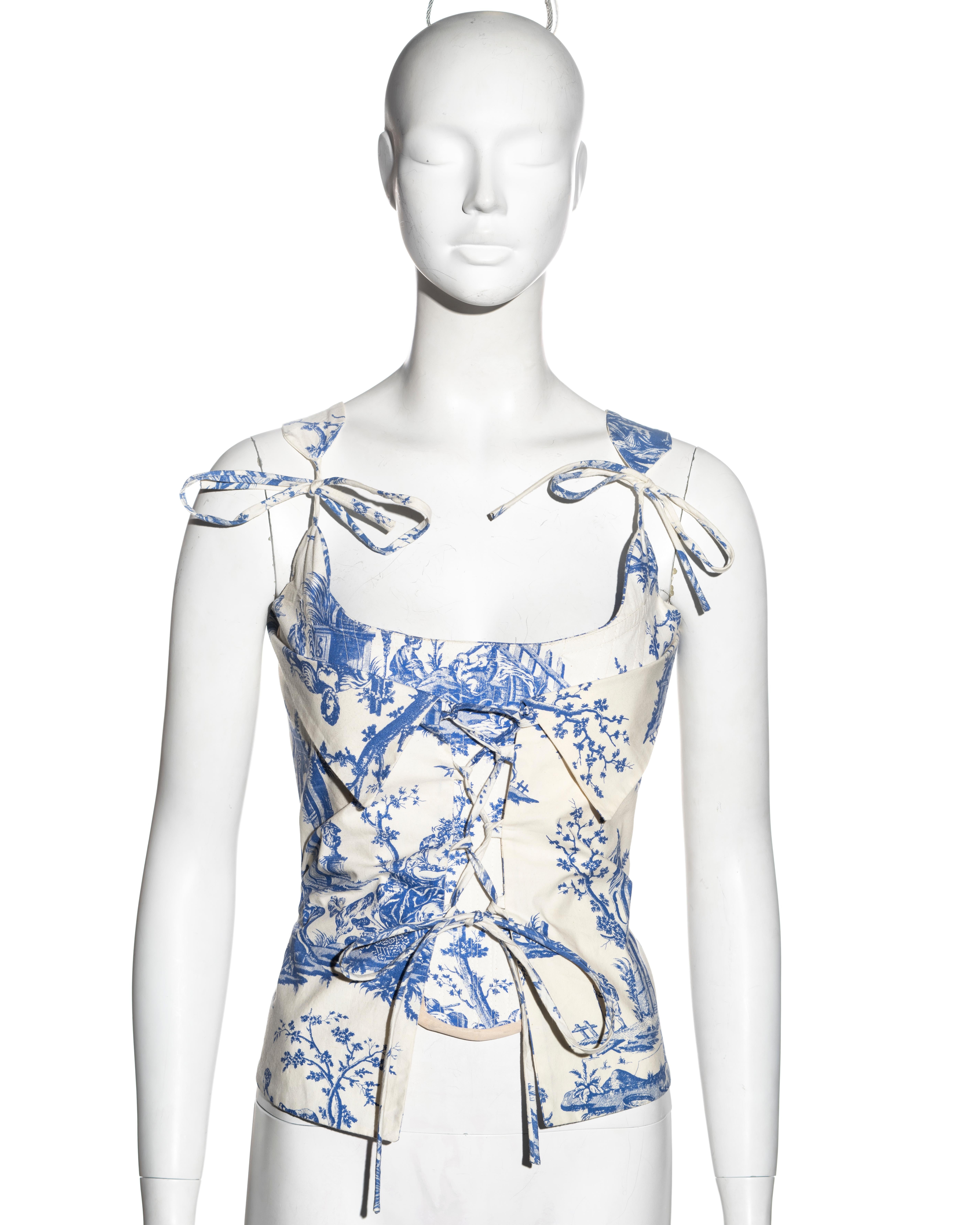 ▪ Vivienne Westwood white cotton corset 
▪ Blue 'Toile de Jouy' print
▪ Boned stomacher 
▪ Matching printed overlay with lace-up fastening and fold-over collar
▪ String ties on the shoulder straps 
▪ Zipper at the centre-back
▪ UK 12
▪ Spring-Summer