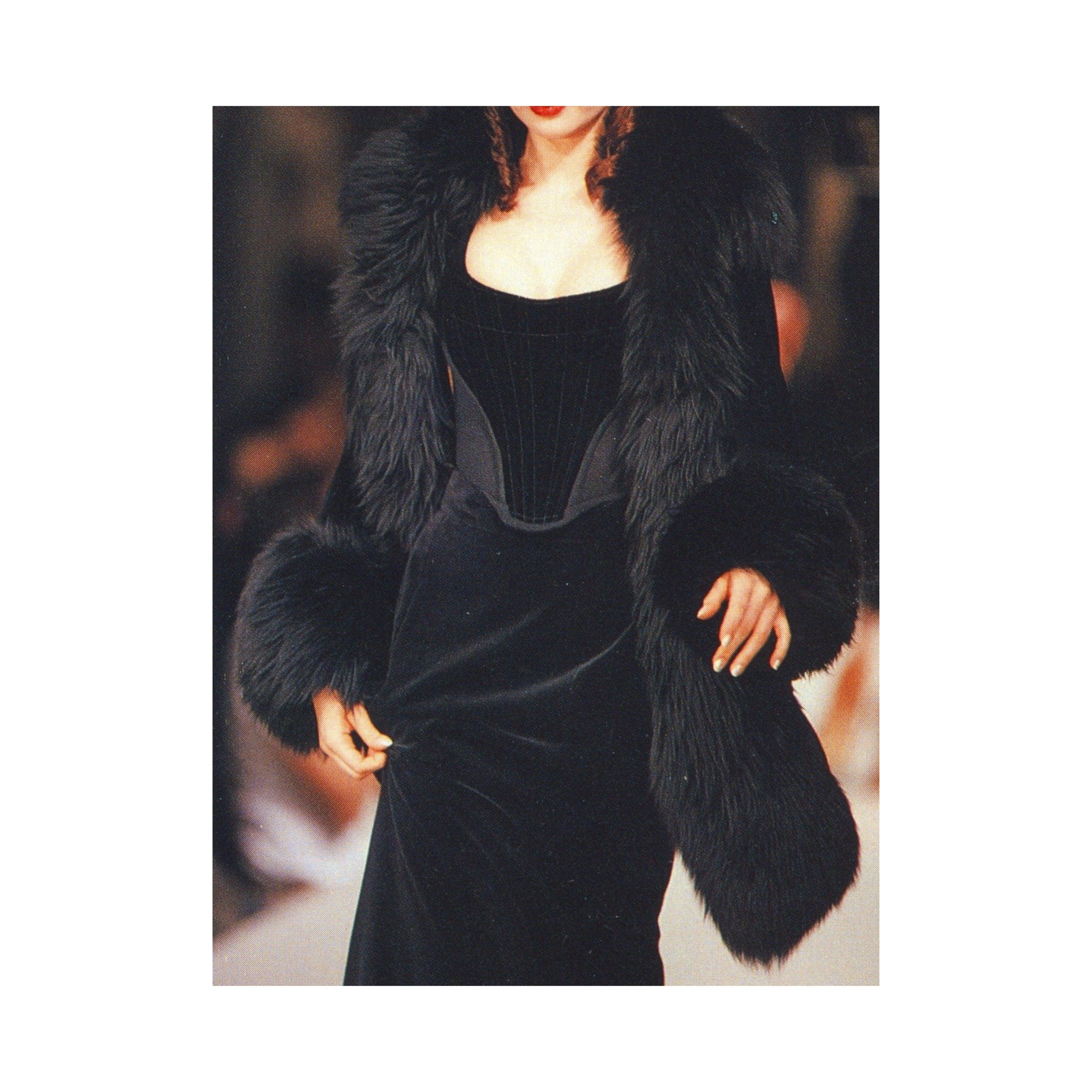 The 18th-century-inspired Vivienne Westwood black velvet corset is straight from the archive of the brand's F/W 1991 collection. It features the original red label from 1993 and is a rare gem with a mixture of horizontal and vertical curved lines on