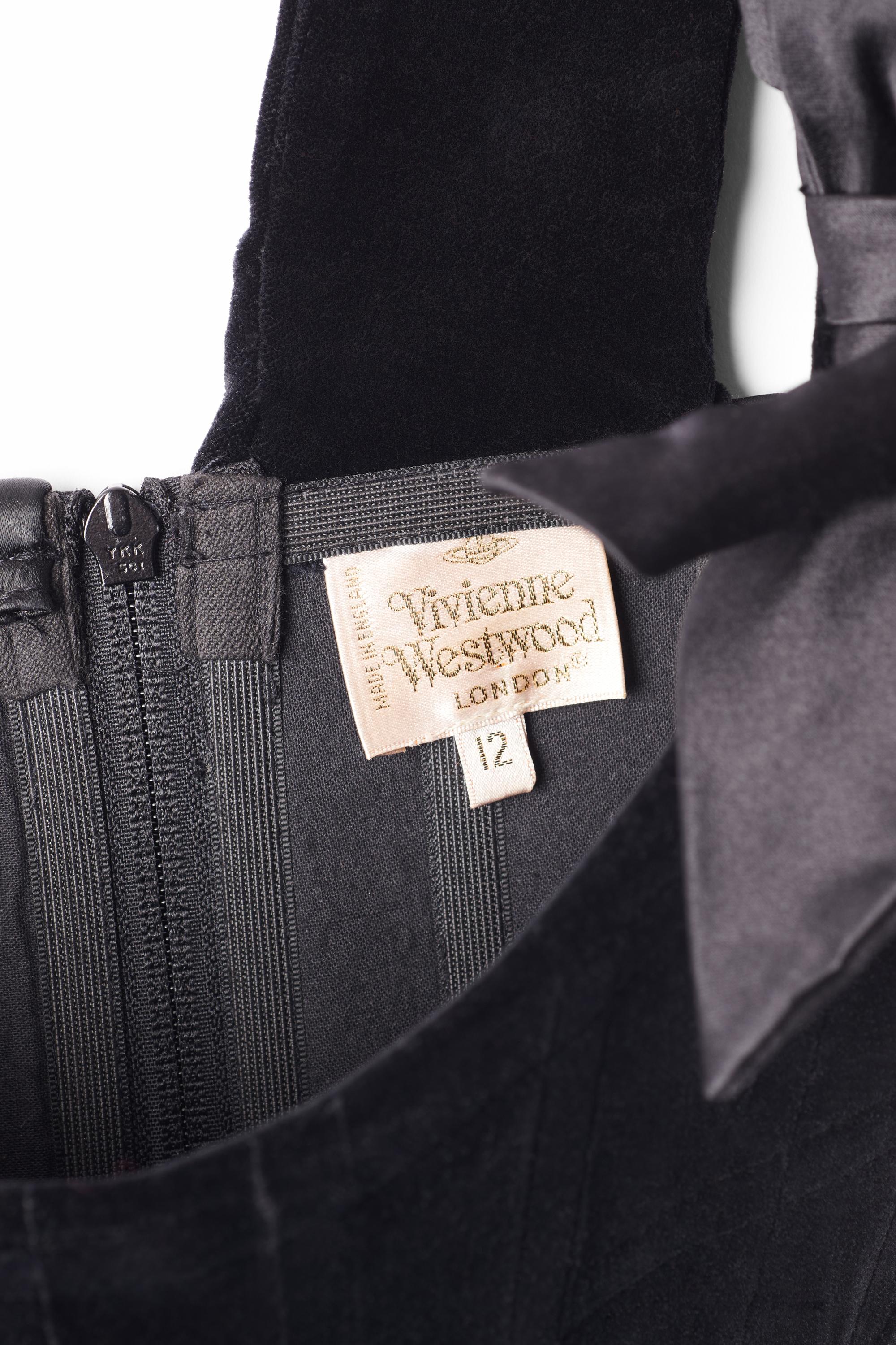 Vintage Vivienne Westwood 1993 black velvet corset. Features boned corset body in the iconic Westwood shape, one shoulder silhouette with bow detailing and zip back closure. In excellent vintage condition. 
Authenticity Guaranteed.

Modern Size: UK: