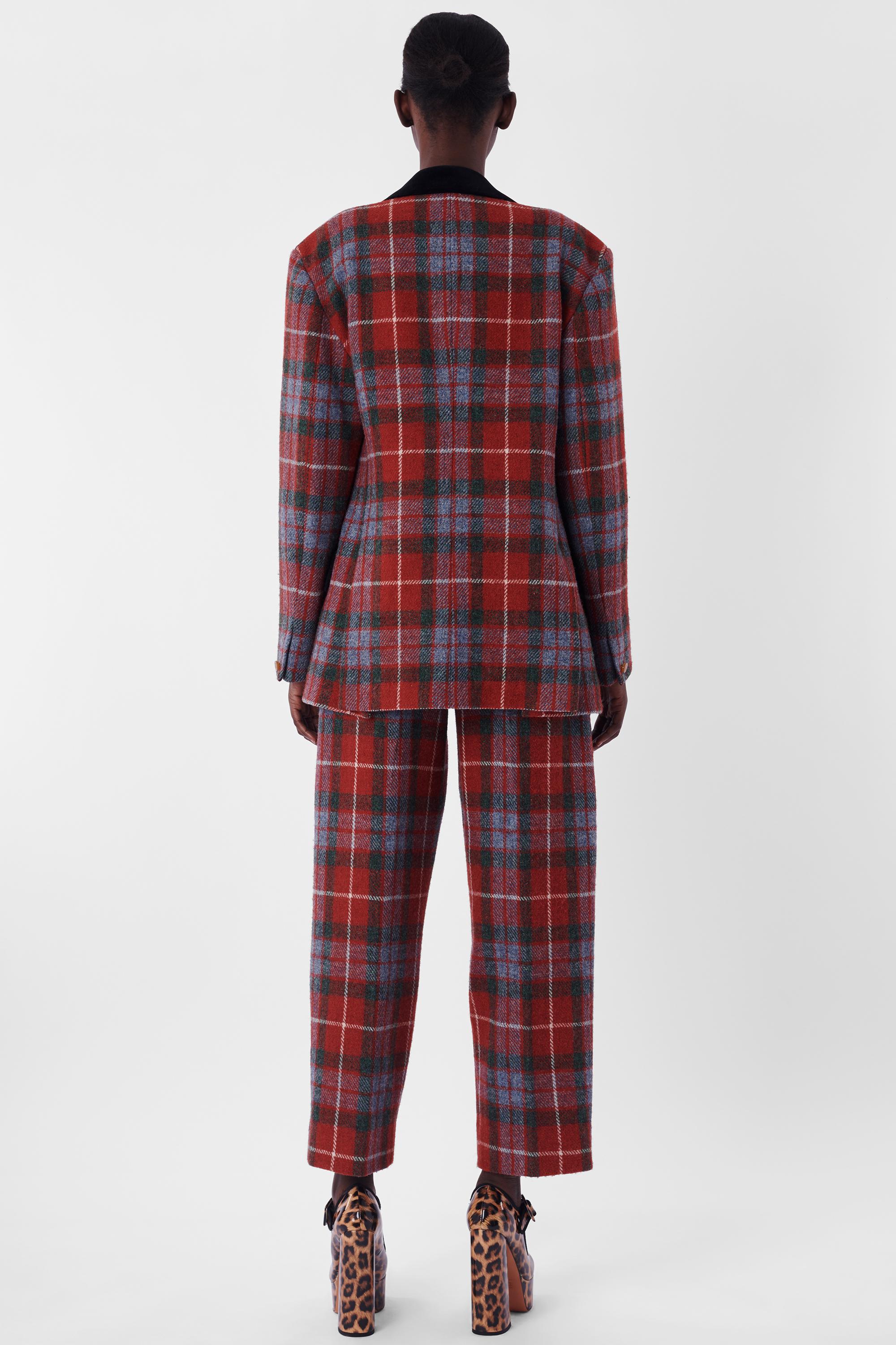We are excited to present this Vivienne Westwood Vintage A/W 1991 Dressing Up Collection Harris Tweed Tartan Suit. Features red tartan with black velvet collar and pocket flaps. High waisted trousers with buckle in the back, hook and zipper for