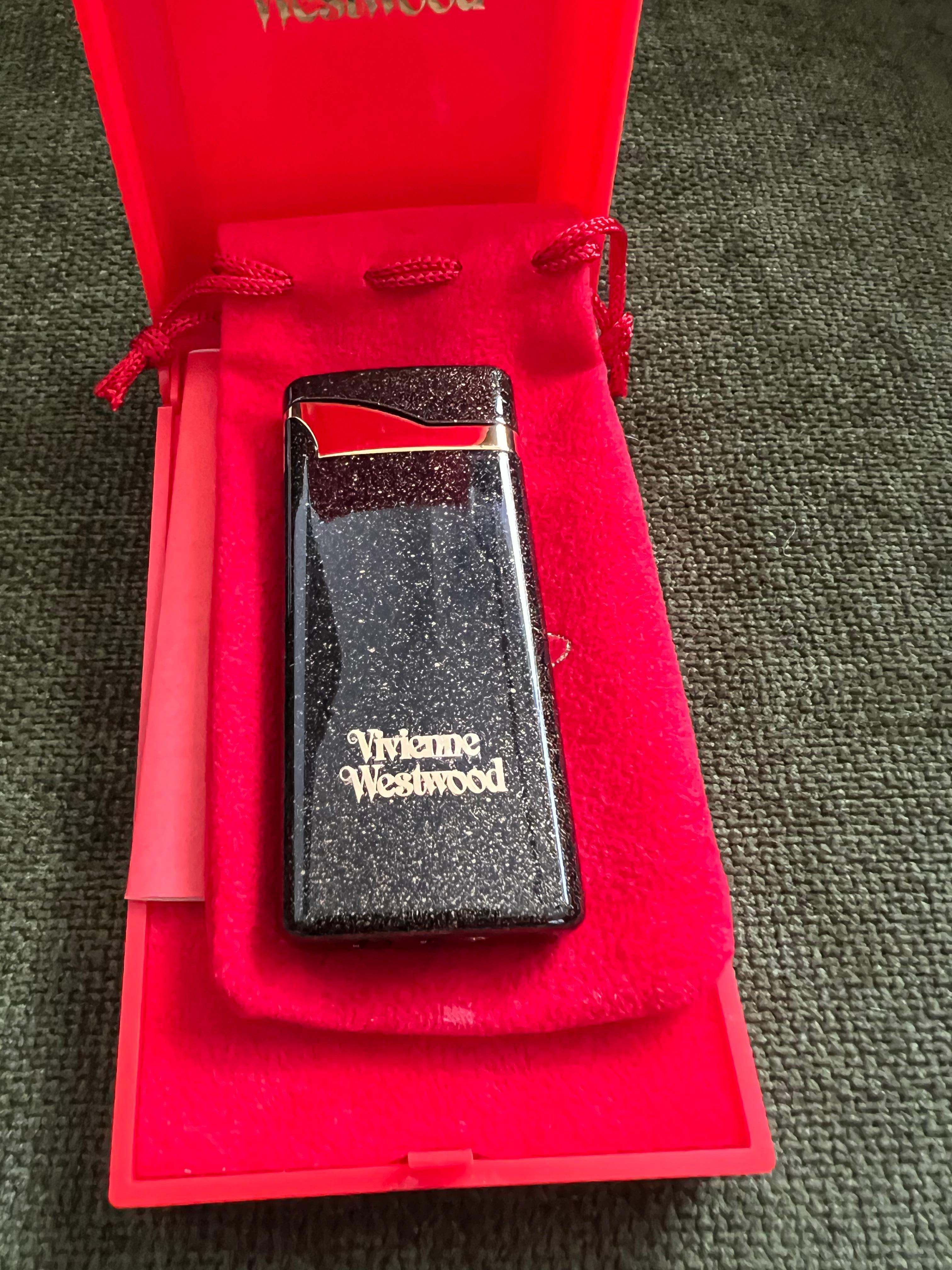 Vivienne Westwood” Black Enamel Lighter
British Punk/Rock 
Westwood has carried her rebellious spirit into her collections throughout her career, often combining punk symbolism with traditional feminine themes, and she's now considered one of the