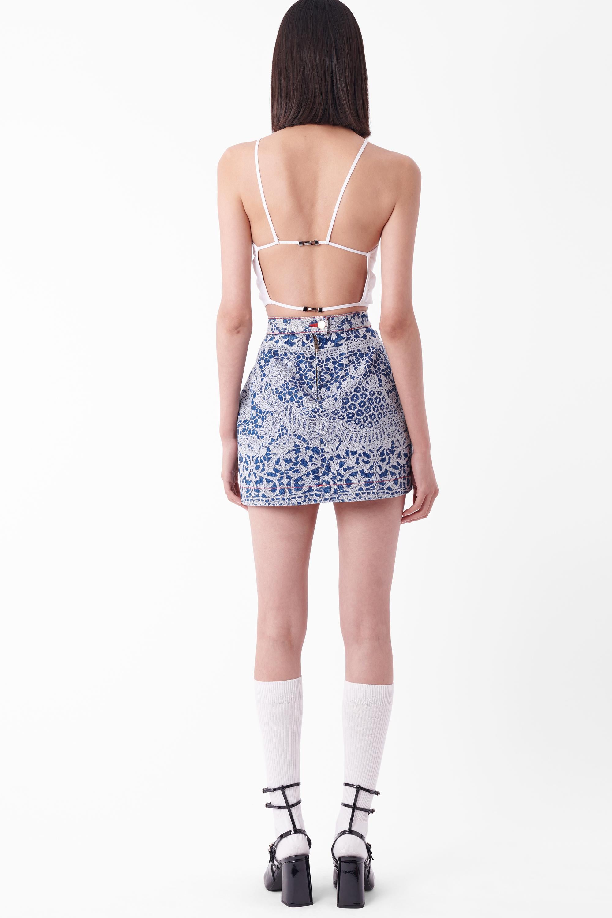 We are excited to present this Vintage Vivienne Westwood Fall Winter 1992 denim mini skirt, from the ‘Always On Camera’ collection. Features iconic lace print, waistline pleating and darting to create an a-line fit, red contrast stitching and double