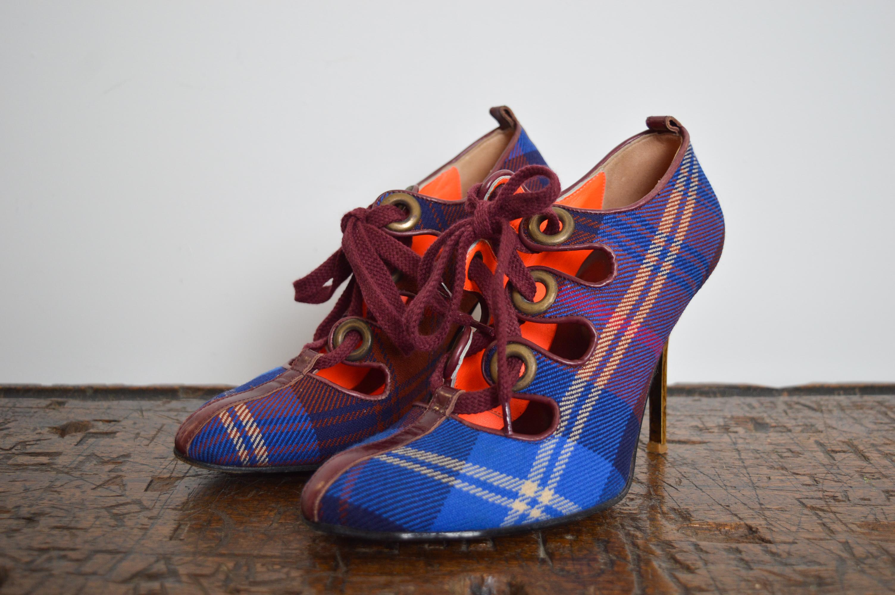 Fabulous Vintage Vivienne Westwood Red & Blue Tartan Lace up High Heeled Shoes !
MADE IN ITALY.
LEATHER soles 
Lace Up brass eyelet detail 
Cracked gold effect stiletto heel
Neon Orange interior leather lining detail
U.K. Size 4.5 / EU Size 37
Heel
