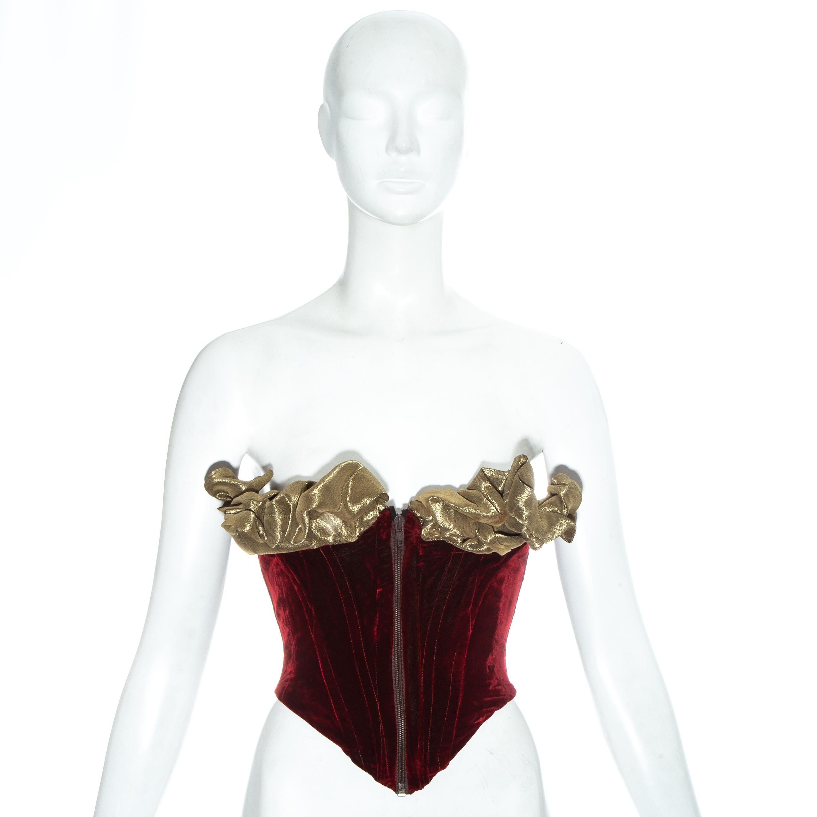 Vivienne Westwood 'Voyage to Cythera' red velvet bustier corset with olive lamé wired bust and front zip fastening. Designed to cinch the waist and push the breasts up.

Fall-Winter 1989