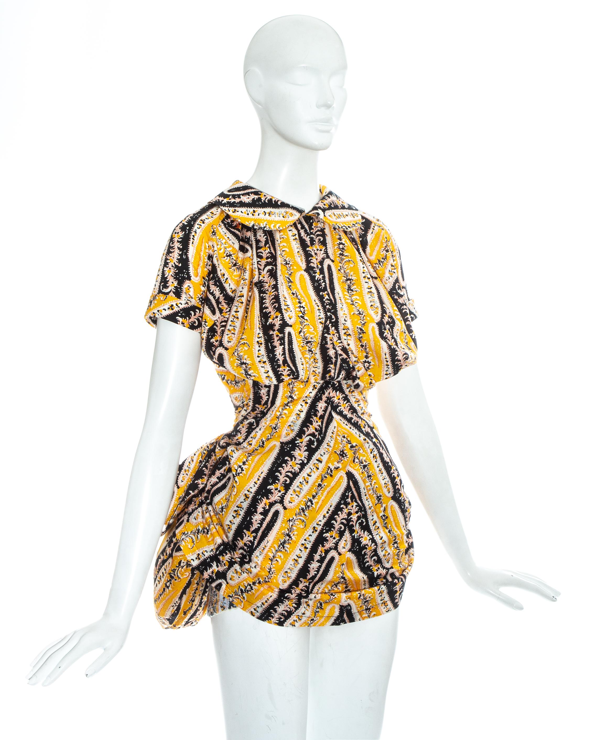 Vivienne Westwood yellow printed cotton draped mini shirt dress. Draped bust with buttons fastenings at the back and pleated skirt. Worn with a matching bustle attached to high waisted panties. 

Spring-Summer 1995