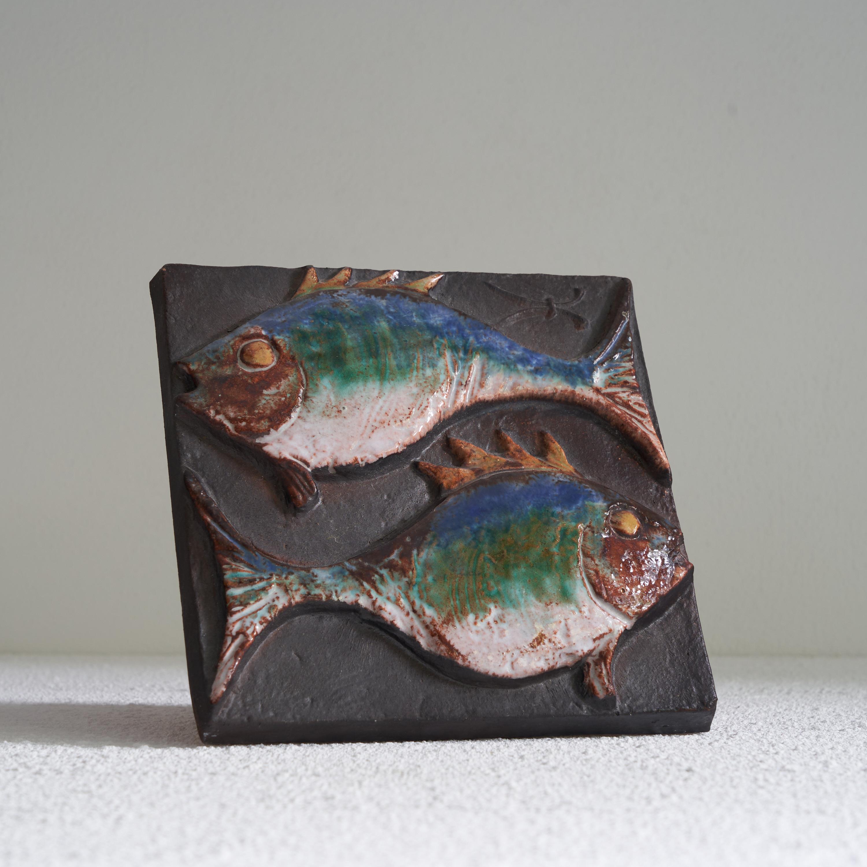 Vladimír David for Jihokera Bechyne Zodiac Tile Fishes / Pisces. Czech Republic, mid 20th century. 

This is a great mid-century studio pottery tile depicting the Zodiac sign of the Fishes / Pisces. It was made by the pottery workshop Johokera