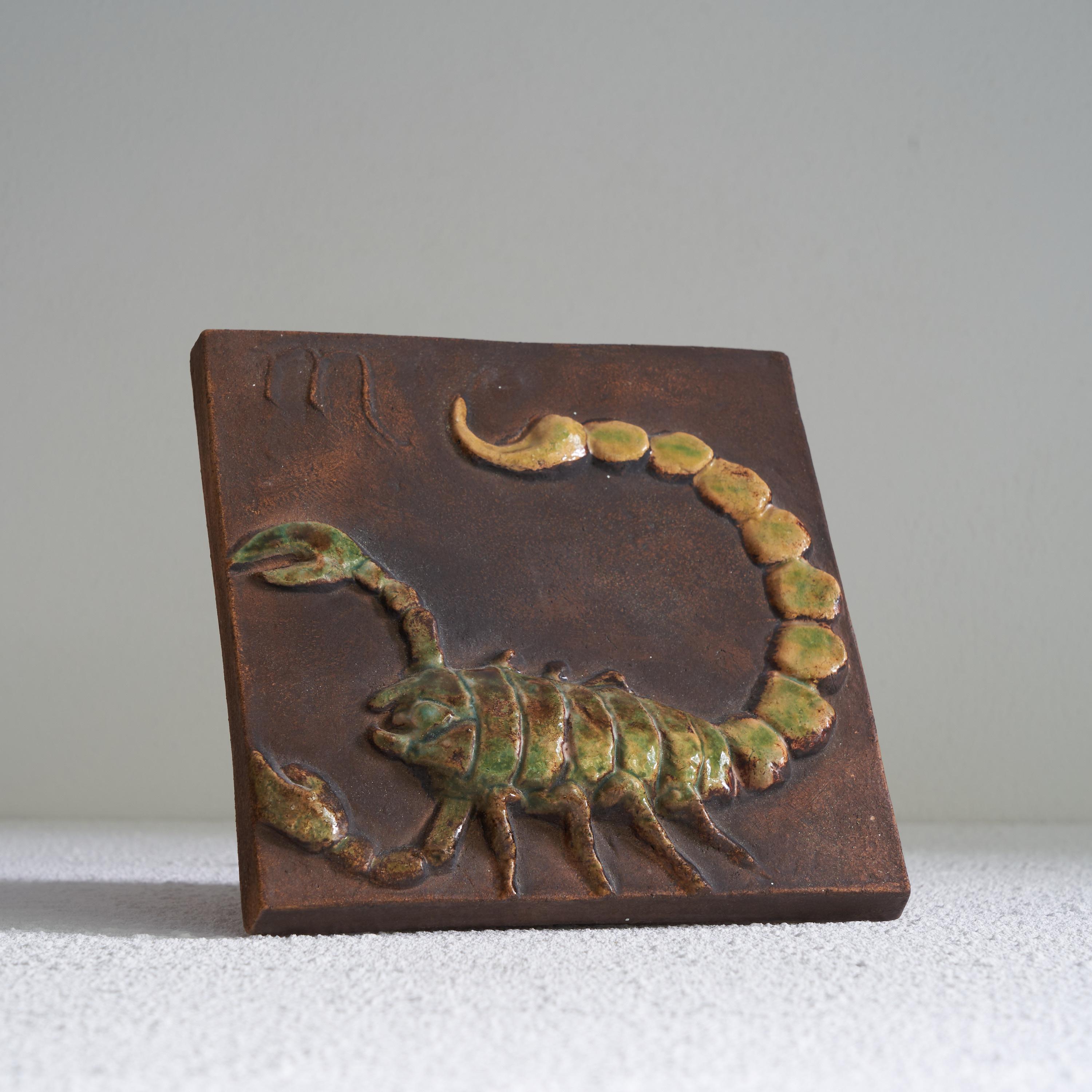Vladimír David for Jihokera Bechyne Zodiac Tile Scorpio / Scorpion. Czech Republic, mid 20th century. 

This is a great mid-century studio pottery tile depicting the Zodiac sign of the Scorpion / Scorpio. It was made by the pottery workshop