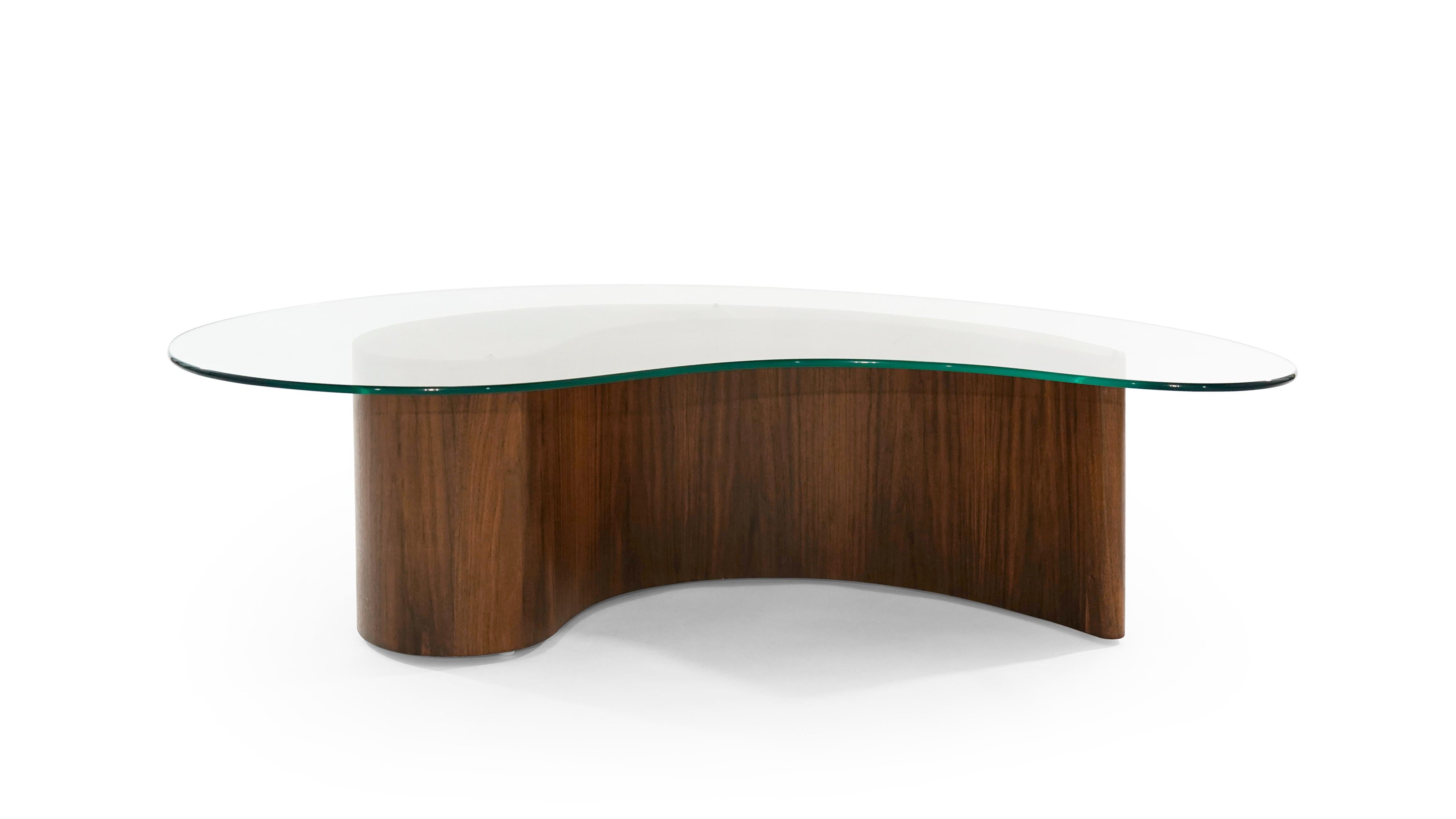An apostrophe shaped coffee table attributed to Vladimir Kagan, circa 1950s. Walnut fully restored, new glass top.