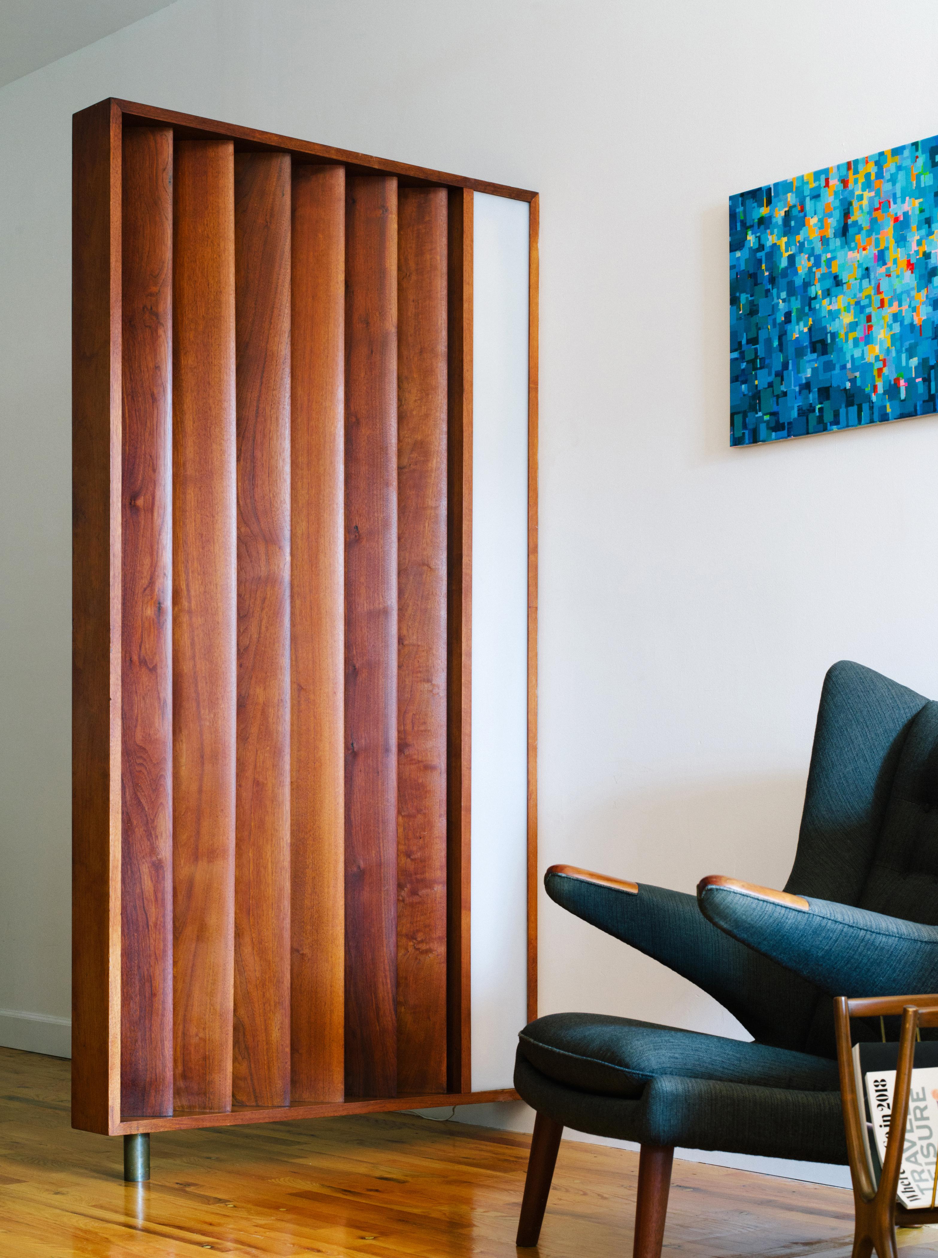 An incredibly rare louvered and illuminated room divider in solid walnut floating over a cylindrical brass foot, custom-designed by Vladimir Kagan circa 1967. Six sculptural, marquise-shaped slats are angled at 45 degrees to the frame and flank the