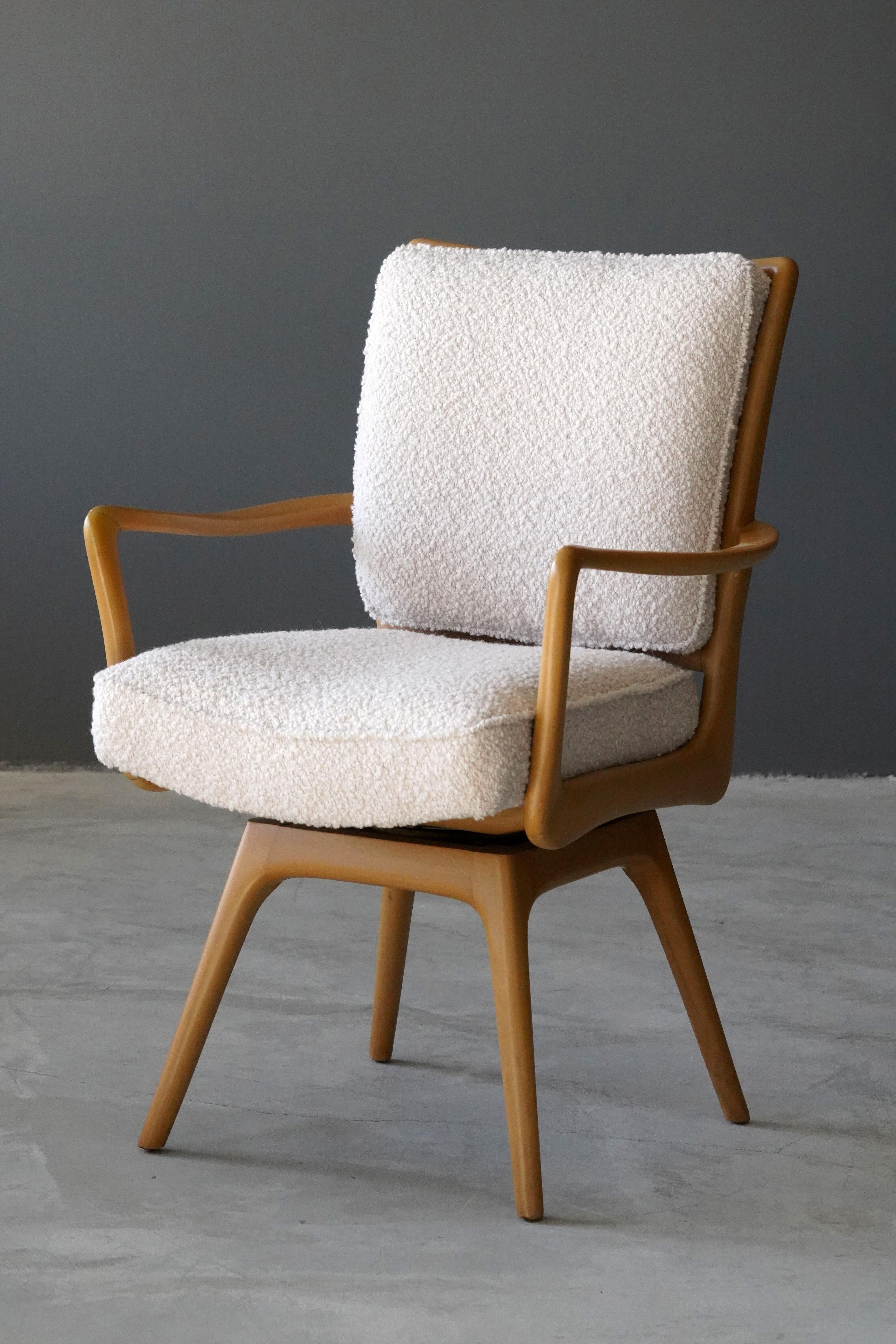 A swiveling organic armchair / desk chair designed by Vladimir Kagan. Organically carved wood is paired with a high-end bouclé fabric. Produced by Kagan-Dreyfus, 1960s. With metal plaque. 

Other designers of the period include Paul Frankl, Gio