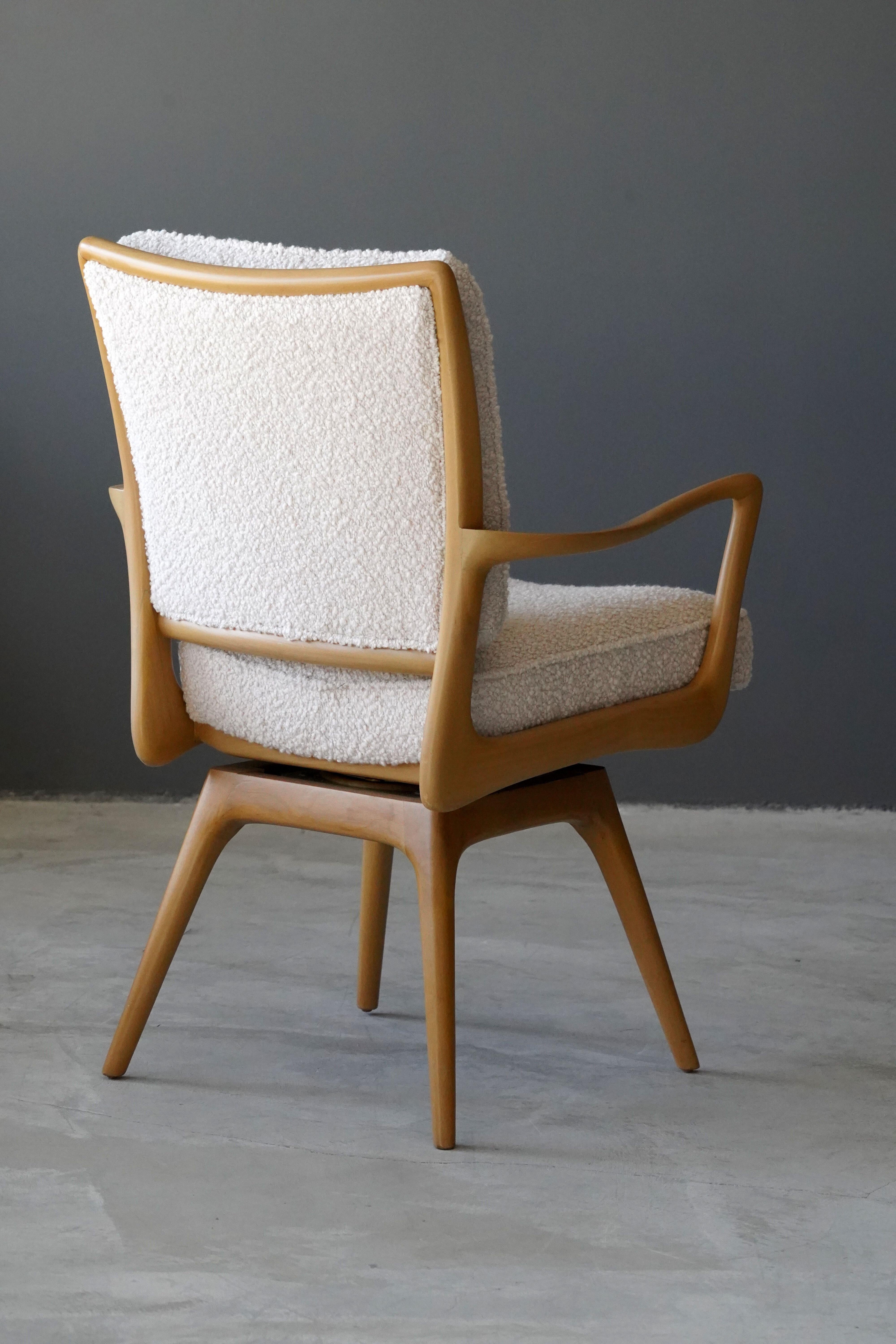 A swiveling organic armchair / desk chair designed by Vladimir Kagan. Organicly carved wood is paired with a high-end bouclé fabric. Produced by Kagan-Dreyfus, 1960s. With metal plaque. 

Other designers of the period include Paul Frankl, Gio