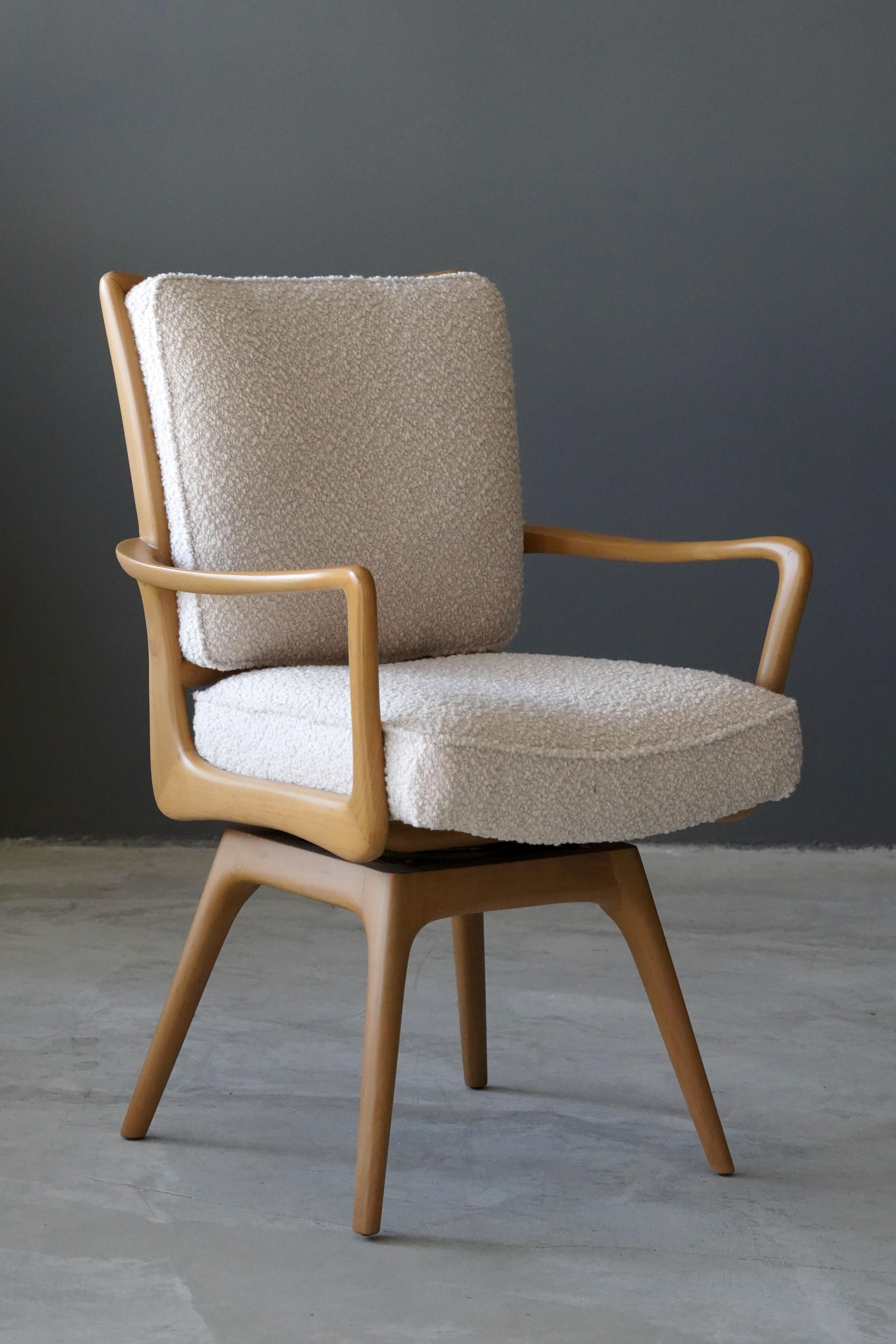A swiveling organic armchair / desk chair designed by Vladimir Kagan. Organically carved wood is paired with a high-end bouclé fabric. Produced by Kagan-Dreyfus, 1960s. With label.

Other designers of the period include Paul Frankl, Gio Ponti,