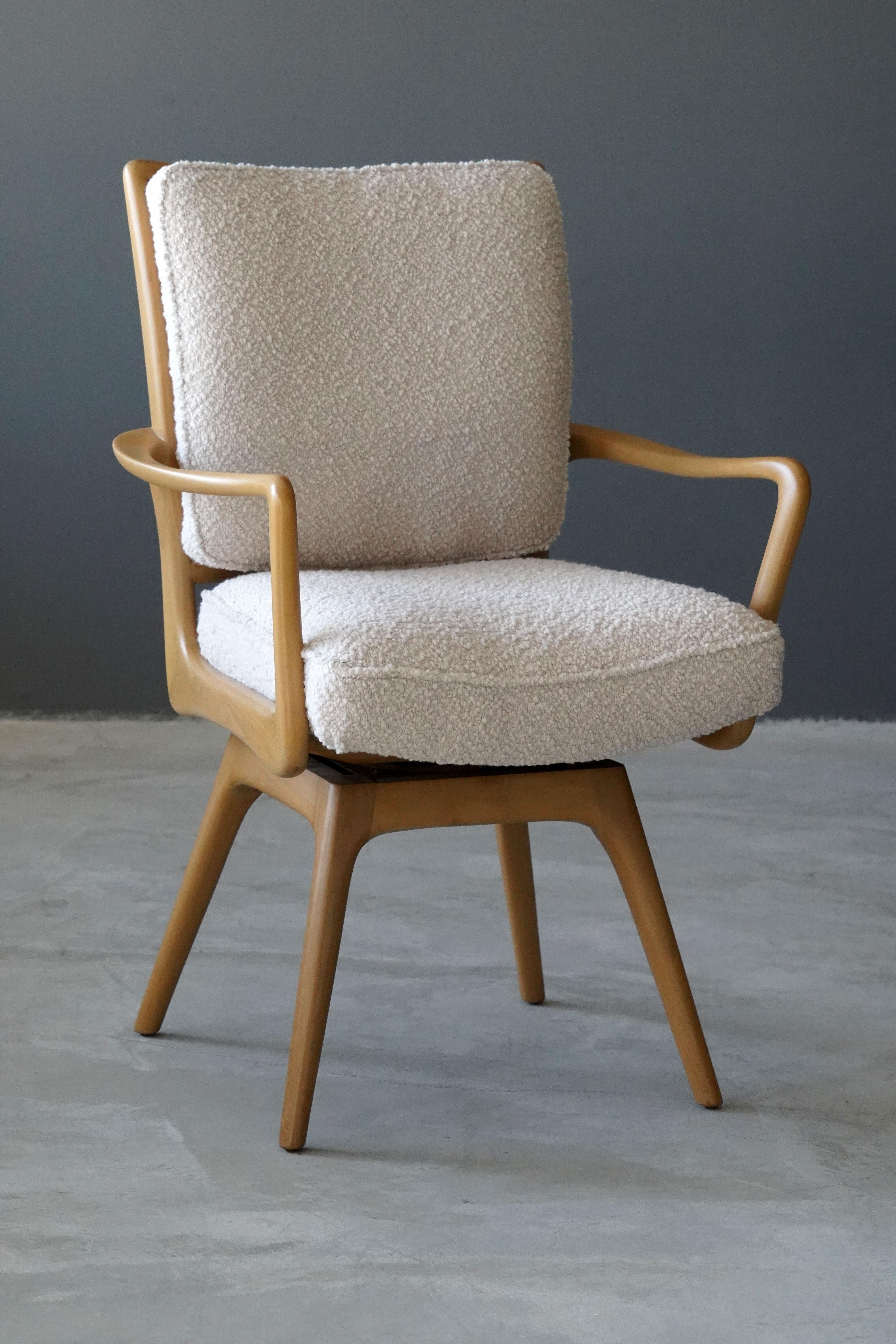 A swiveling organic armchair / desk chair designed by Vladimir Kagan. Organicly carved wood is paired with a high-end bouclé fabric. Produced by Kagan-Dreyfus, 1960s. With metal plaque. 

Other designers of the period include Paul Frankl, Gio