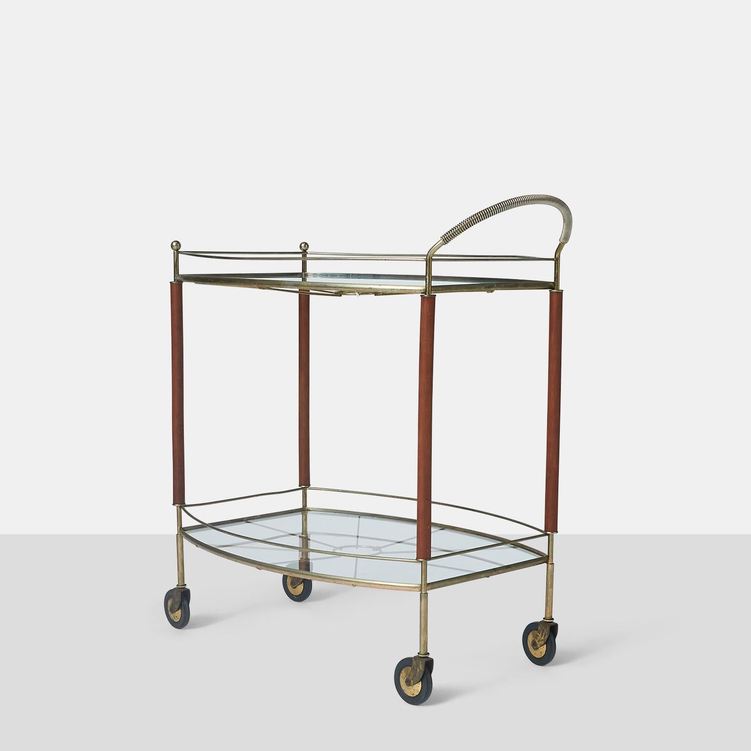 A brass, glass, and mahogany tea trolley on casters.


Measure: Highest part 31