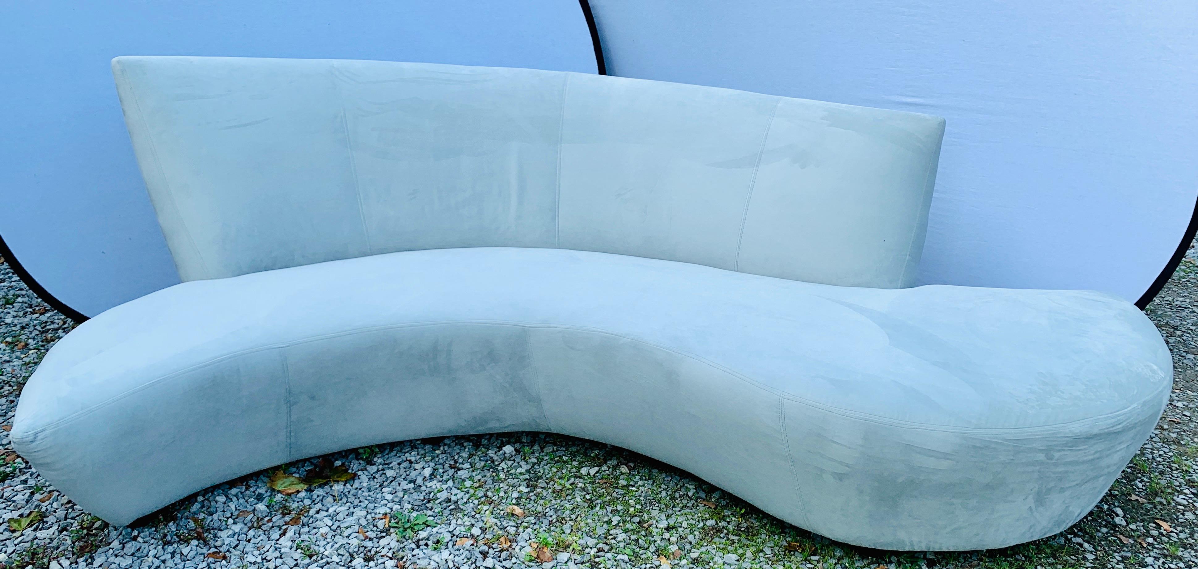 A sculptural Mid-Century Modern style sofa designed by Vladimir Kagan and inspired by the curves and undulations of the Guggenheim Museum in Bilbao Spain. It was newly reupholstered last year and is stunning. Rare to see a serpentine Kagan sofa in