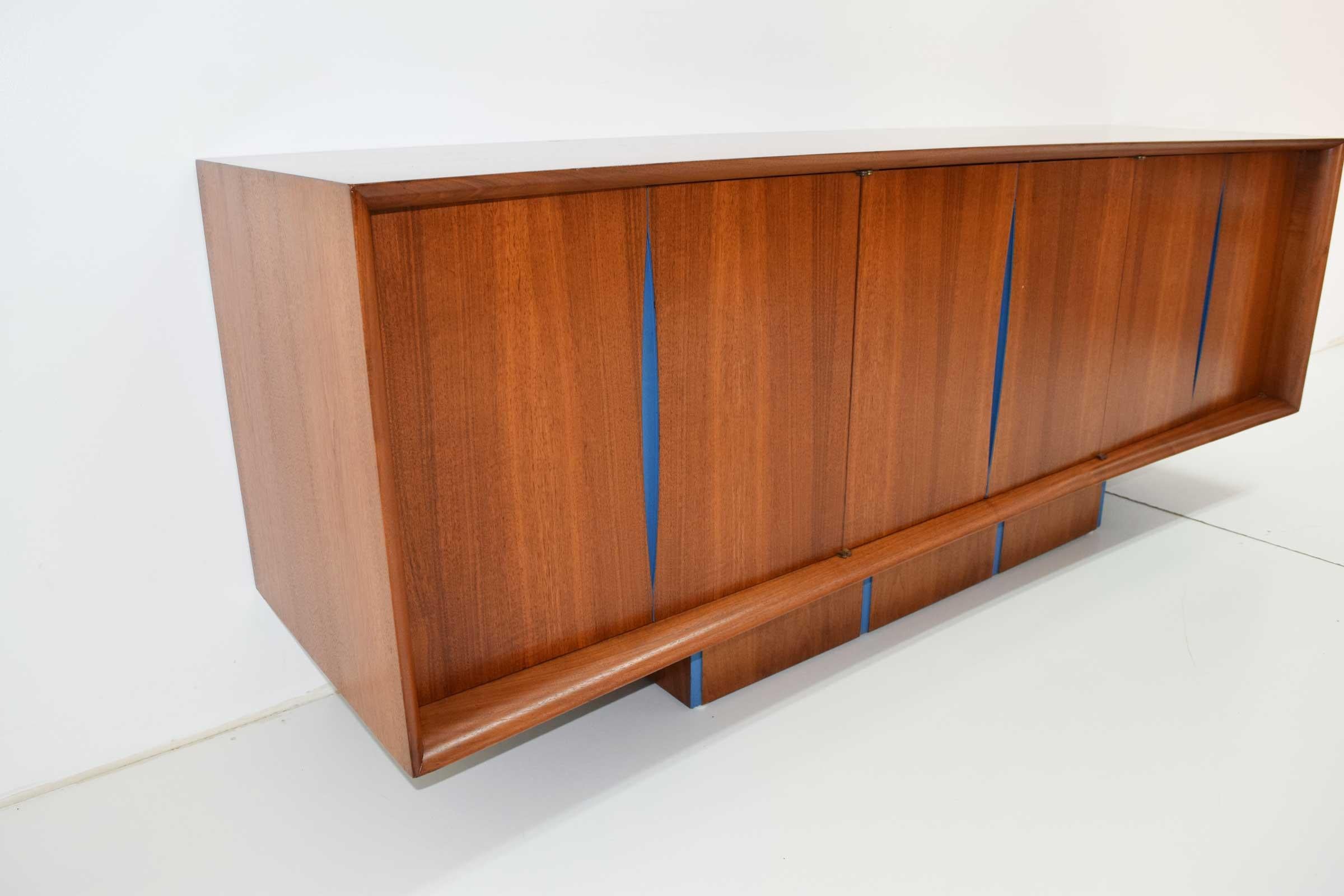 Made by Kagan-Dreyfuss in the 1950s. Cherrywood. This credenza has a upper storage unit available with it that has glass doors and shelving. Refer to photos. The cabinet has been painted the blue to accent the design. This can be refinished to