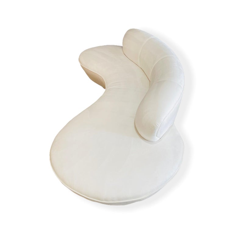 Serpentine sofa designed by the late Vladimir Kagan for Directional, circa 1980s. This rare example features an white ultrasuade upholstery with three round white base. The sofa is in good vintage condition. We also have the enclosed version and a