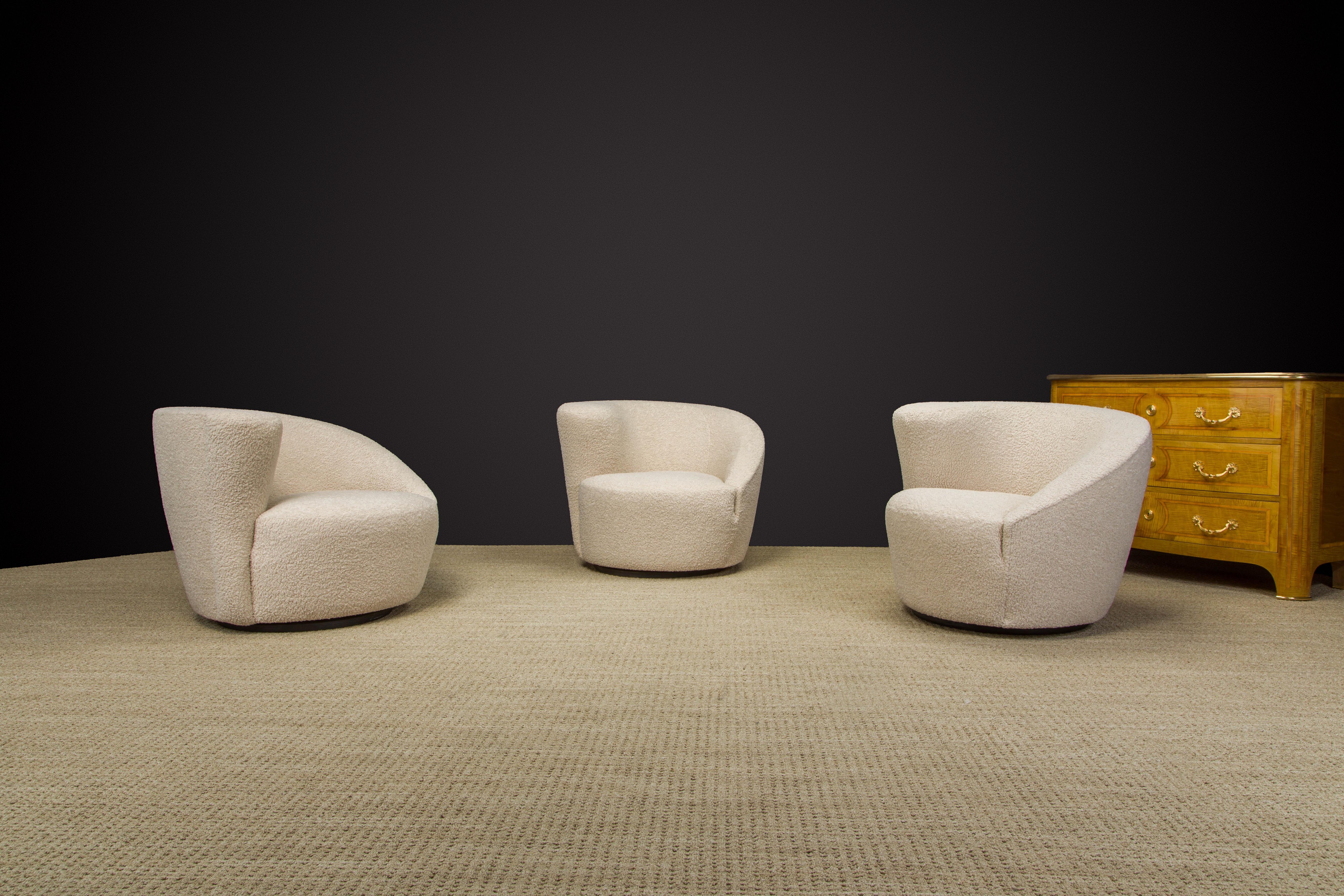 Newly reupholstered in a soft and nubby light beige bouclé, these 'Corkscrew' swivel chairs, also often referred to as 'Nautilus', by Vladimir Kagan for Directional, circa 1980s / 90s are signed with Directional labels underneath. These classic