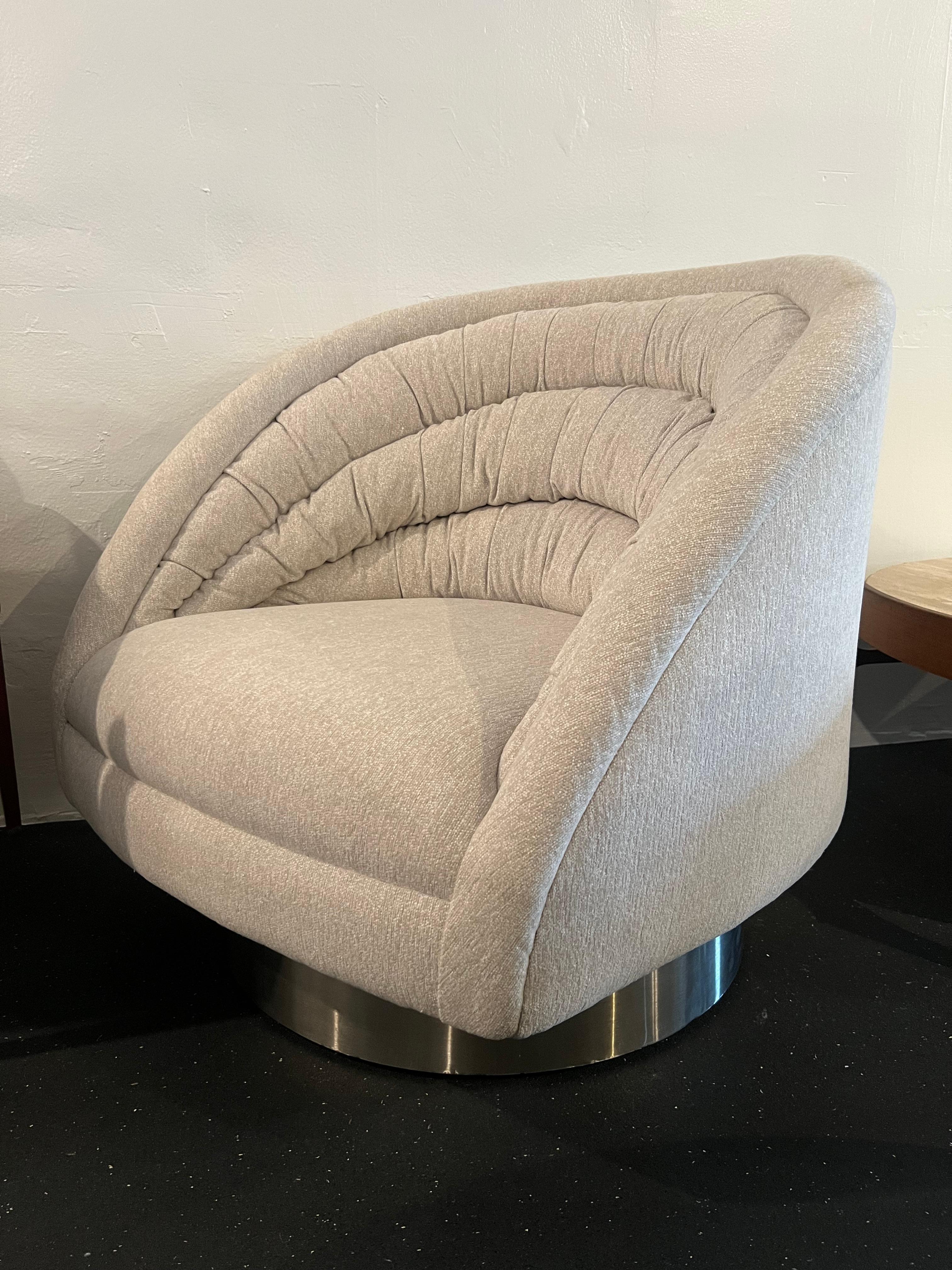 Vladimir Kagan crescent lounge chair. Chair sits on a swivel aluminum wrapped plinth base. Base has some small indentations. Newer upholstery in a gray chenille blend fabric and newer foam that shows minor signs of wear. Please refer to photos