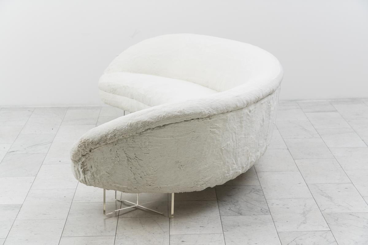 Commissioned directly from Vladimir Kagan Inc. in 1969 (documentation included), this curved floating sofa was a custom commission, and is the only one of its kind. With a rounded back and sleek low profile the sofa rests on Plexiglas bases. Kagan