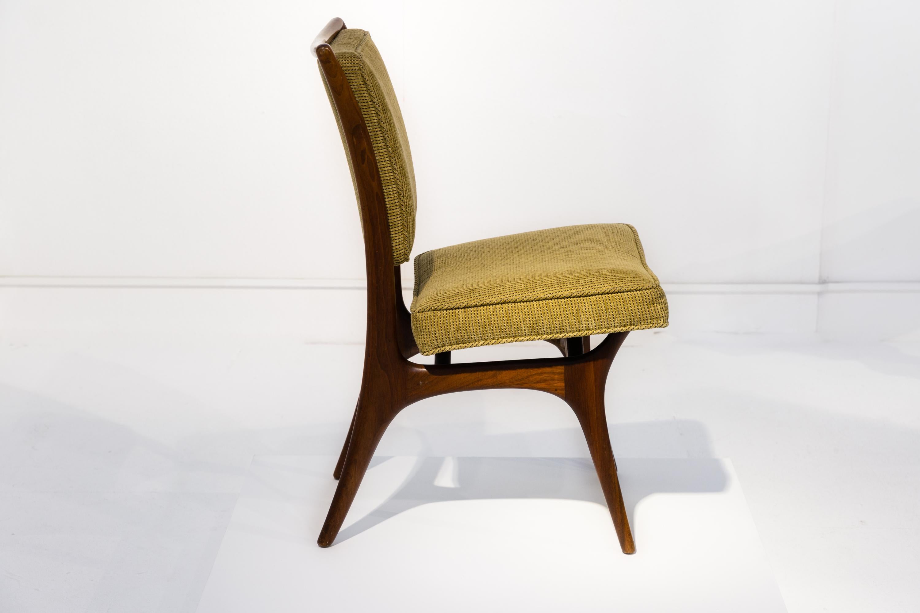 An original Vladimir Kagan dining chair with signature, in very good condition, from the 1950s. Sculptural walnut frame, upholstered seat and back.