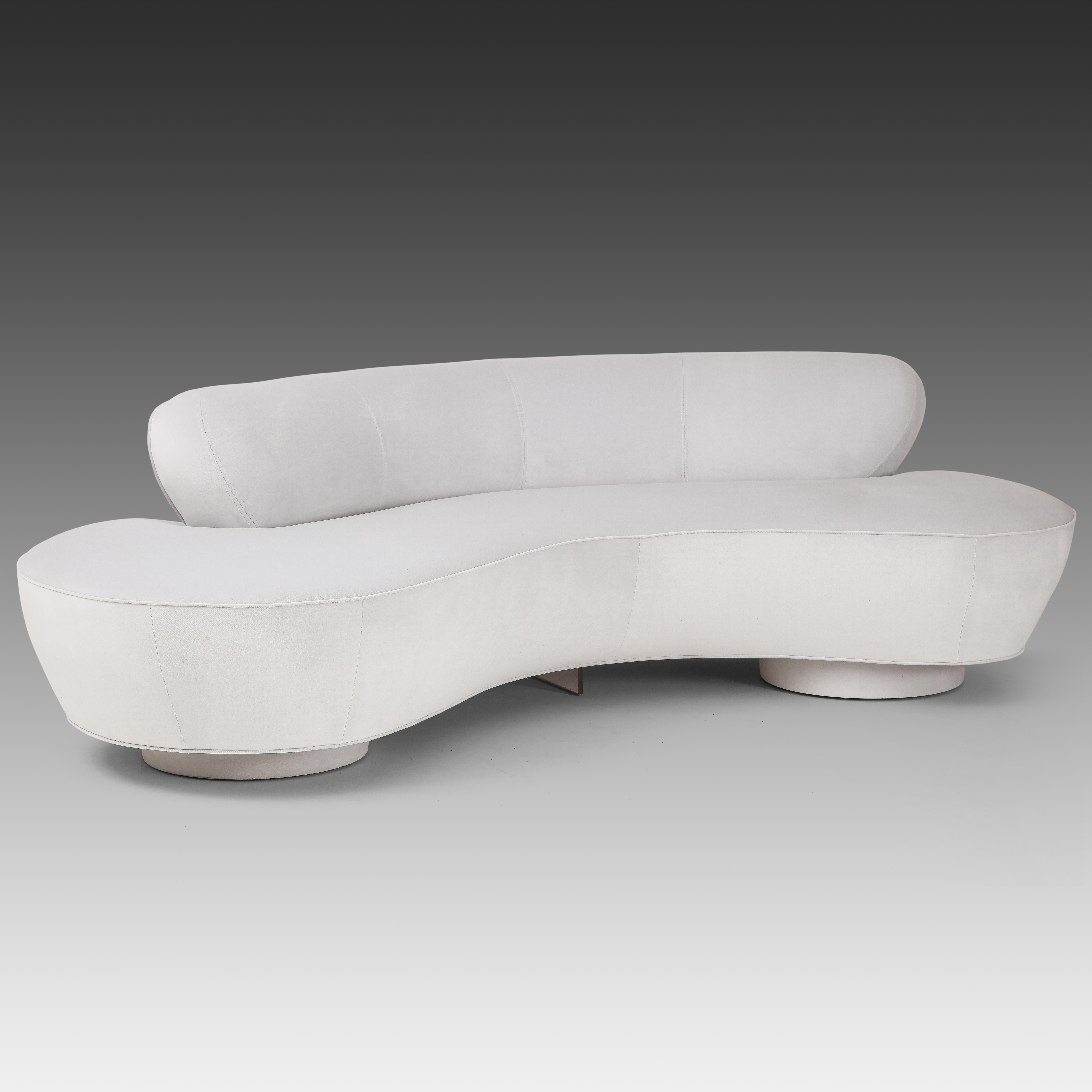 Vladimir Kagan for Directional iconic curved sofa with characteristic upholstered round plinth bases and Lucite stretcher.  This sofa has recently been restored and reupholstered in very pale gray velvet fabric.

Literature:
The Complete Kagan: A