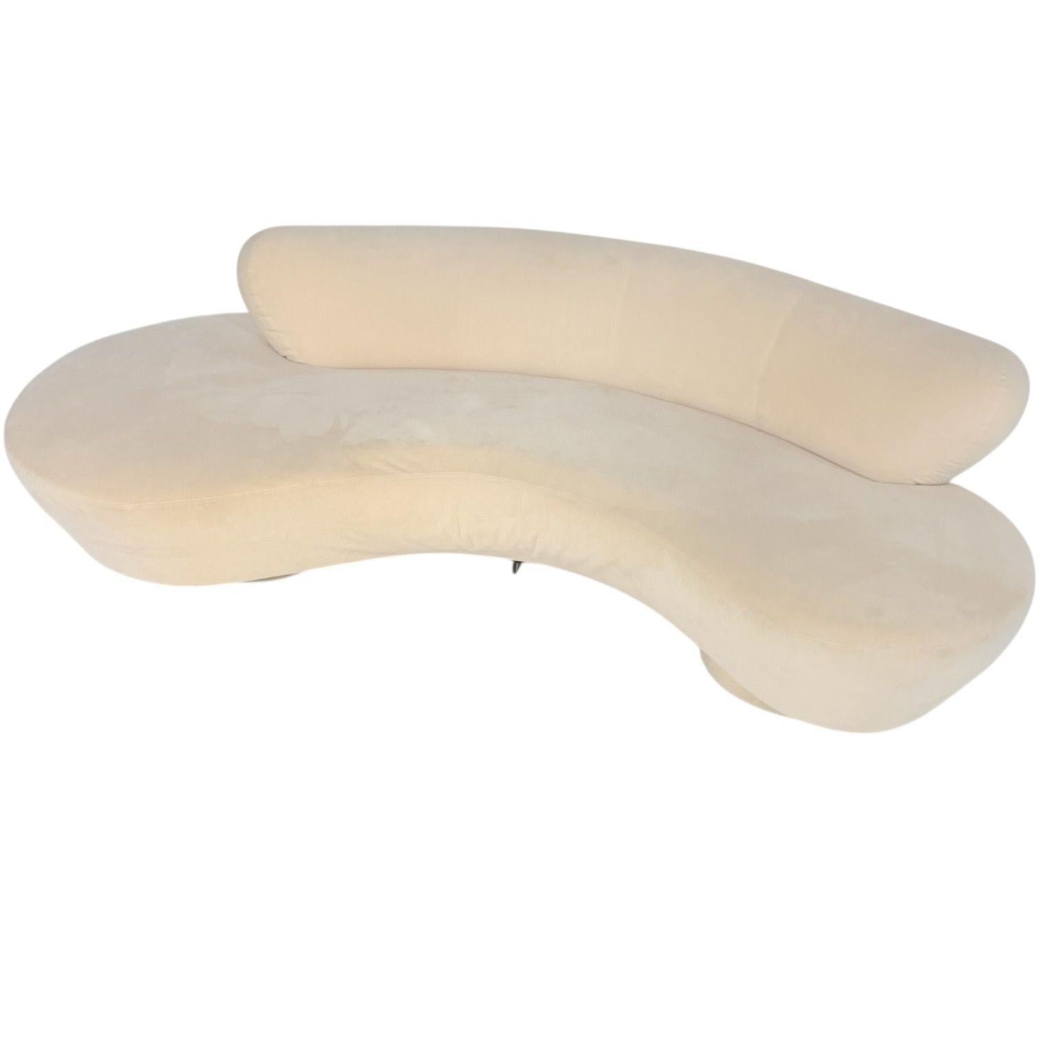 Vladimir Kagan for Directional Serpentine Clound Sofa, 2000’s.  Sofa is original white micro suede. Has 2 round plinth bases and 1 lucite leg in middle.  There are a couple stains on back and a few tears which have been repaired.
Measures 28.5” tall