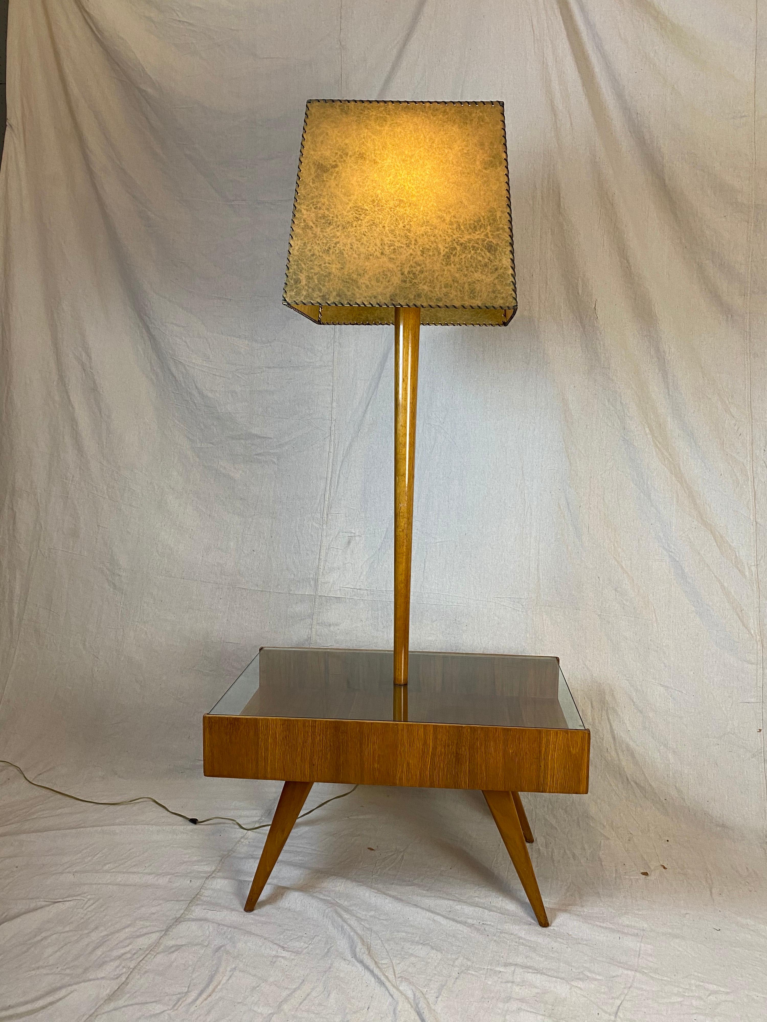 Vladimir Kagan for Kagan Dreyfuss table/ floor lamp. Table has a glass top that allows for Storage of books and Magazines. Splayed tapered legs support the cabinet. Commissioned in 1954 for a Gentleman's Apartment,  until recently living in its