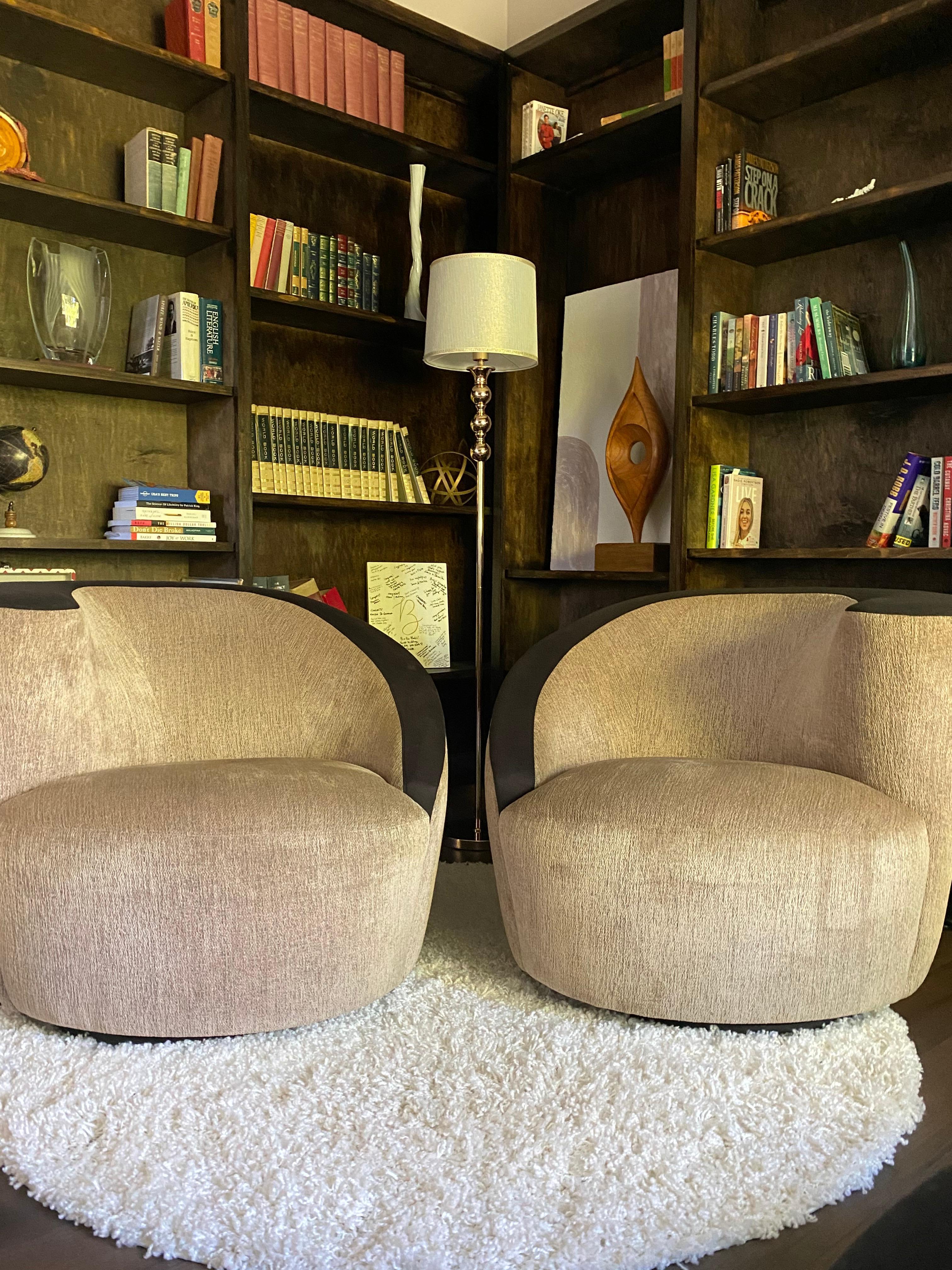 Beautiful pair of vintage swivel chairs from Weiman Furniture Co., circa 1970s. Both chairs have been reupholstered professionally in the last decade, in a tan/beige soft chenille and a black suede top. Original tags are on both chairs as well,