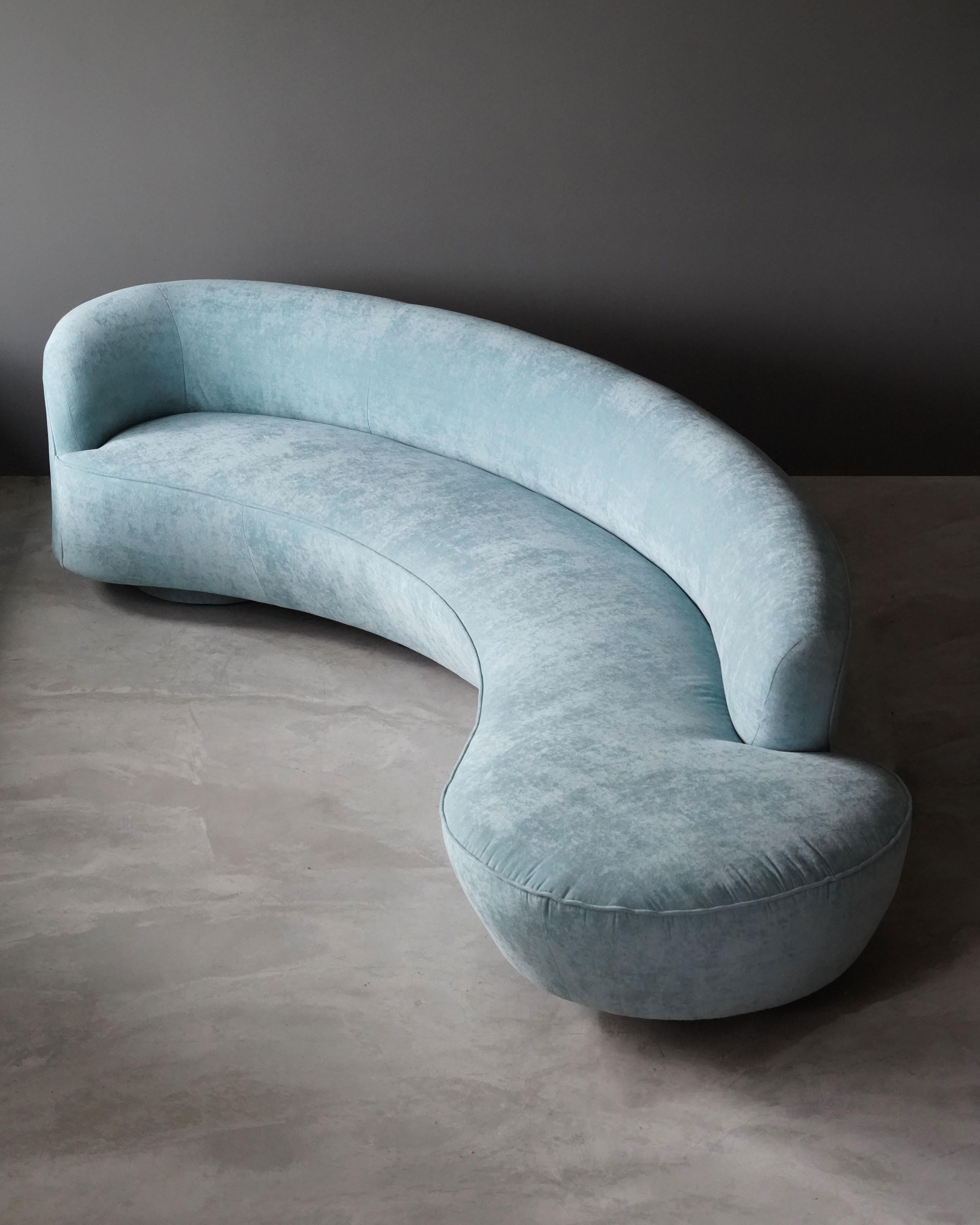 A curved serpentine sofa by Vladimir Kagan. Upholstered in grey faux-mohair fabric. Form referencing the early organic design movement. Executed by Directional.

Other designers of the period include Isamu Noguchi, George Nakashima, Gio Ponti, and