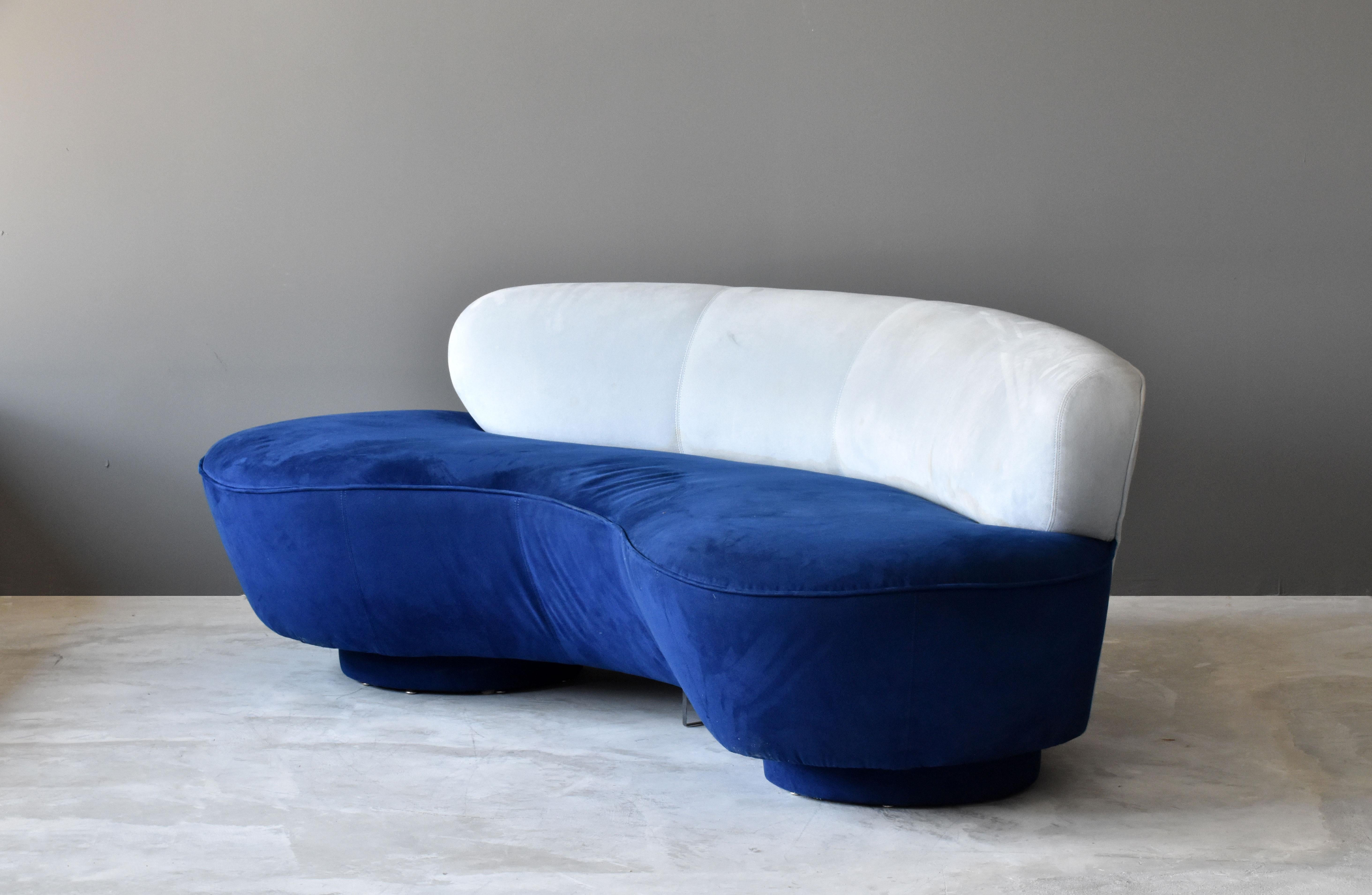 A curved serpentine sofa by Vladimir Kagan. In it's original suede fabric. Form referencing the early organic design movement. Executed by Directional.

    

    
