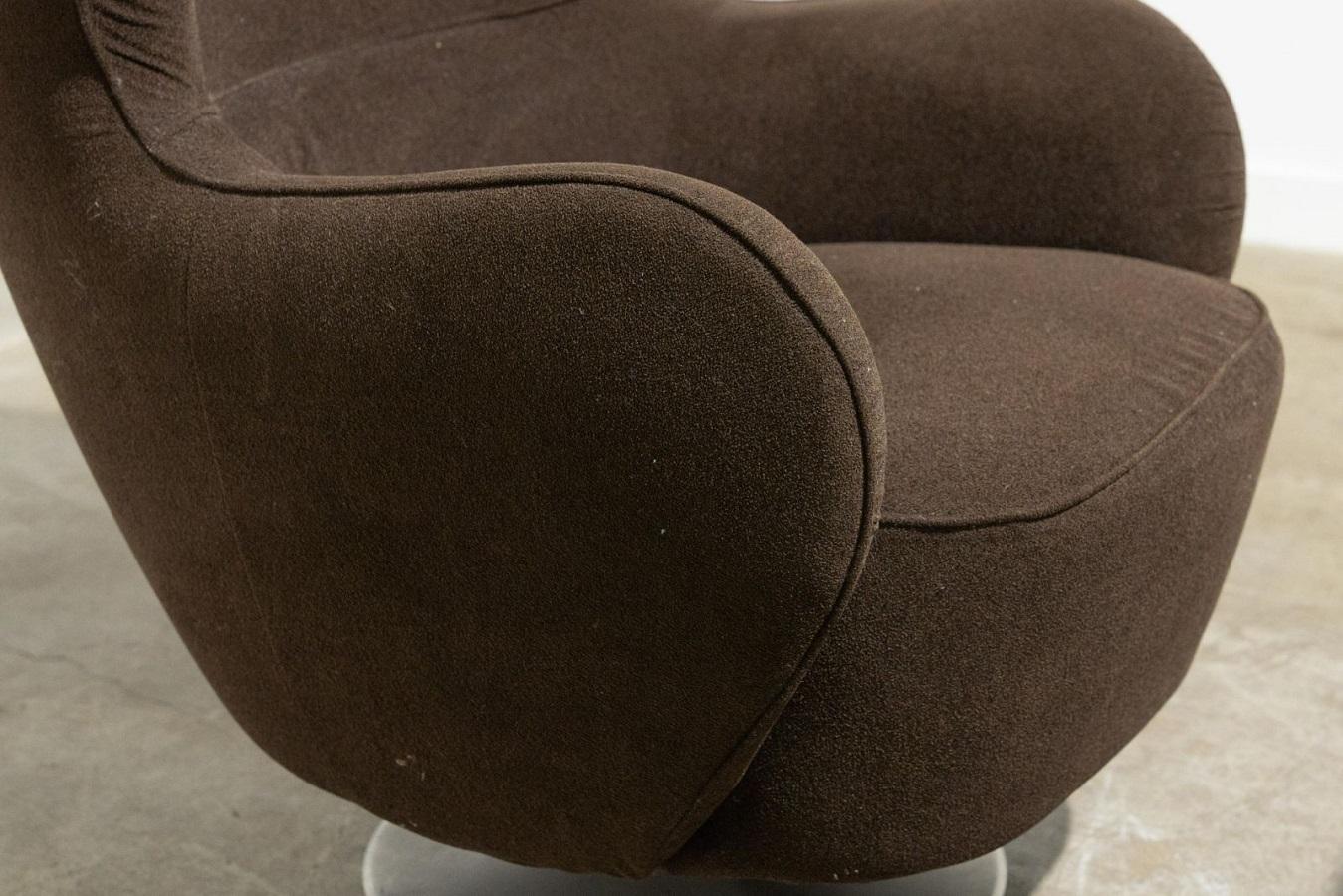 Vladimir Kagan lounge chair and matching ottoman. The set has it's original brown fabric, a pedestal chrome base with Kagan label.
