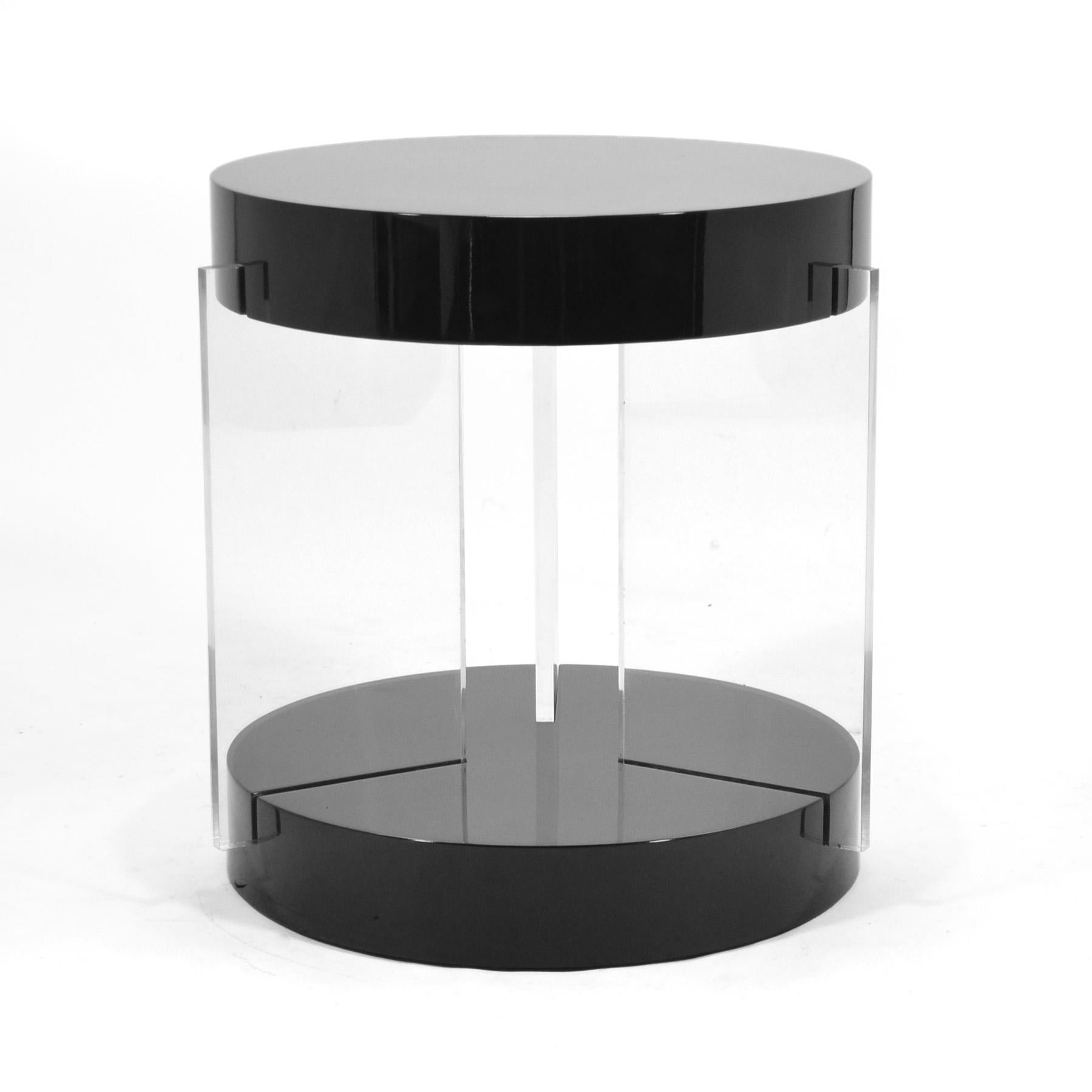A compelling combination of luxurious materials come together in a Classic form to create a table with a wide variety of uses. This Vladimir Kagan table has a black lacquered top supported by three Lucite slab legs. The scale makes it a perfect end