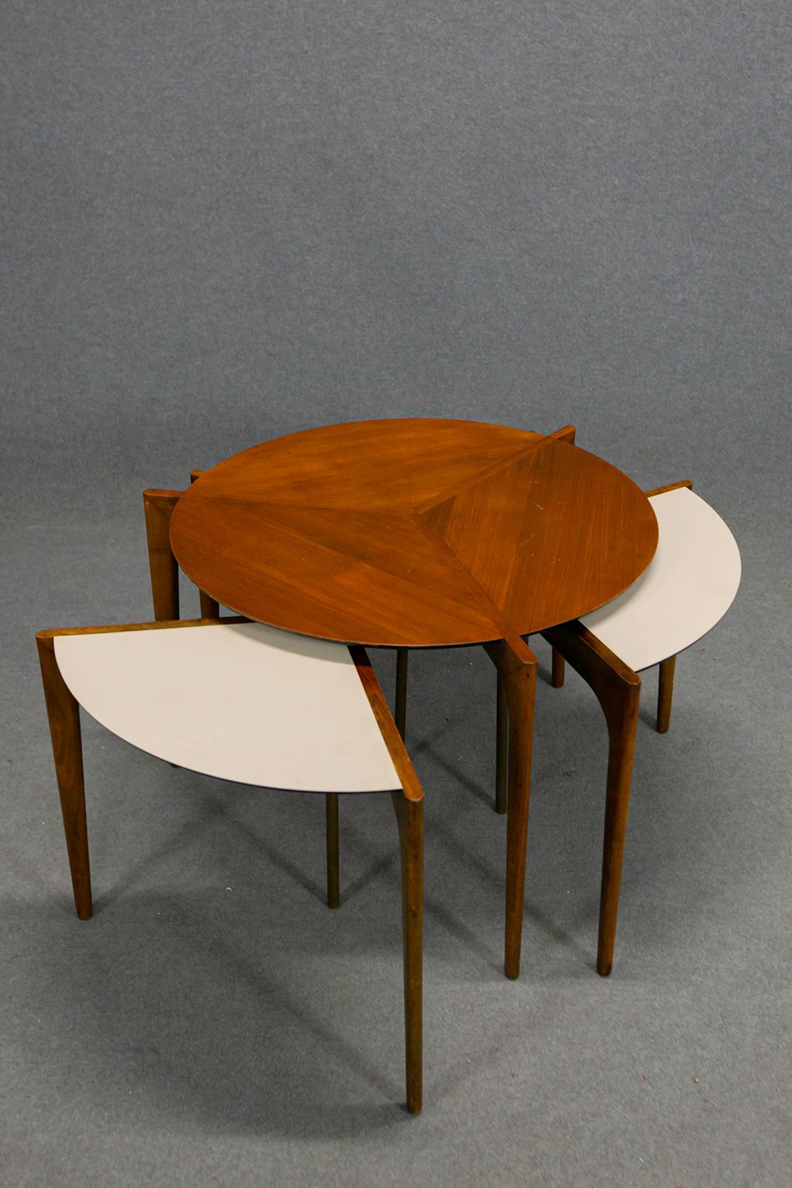 Rare wooden table by Vladimir Kagan with removable modular elements. The central table has three other small tables in the shape of segments underneath its supporting table. The table then opens to give space to three other elements. Their shelves