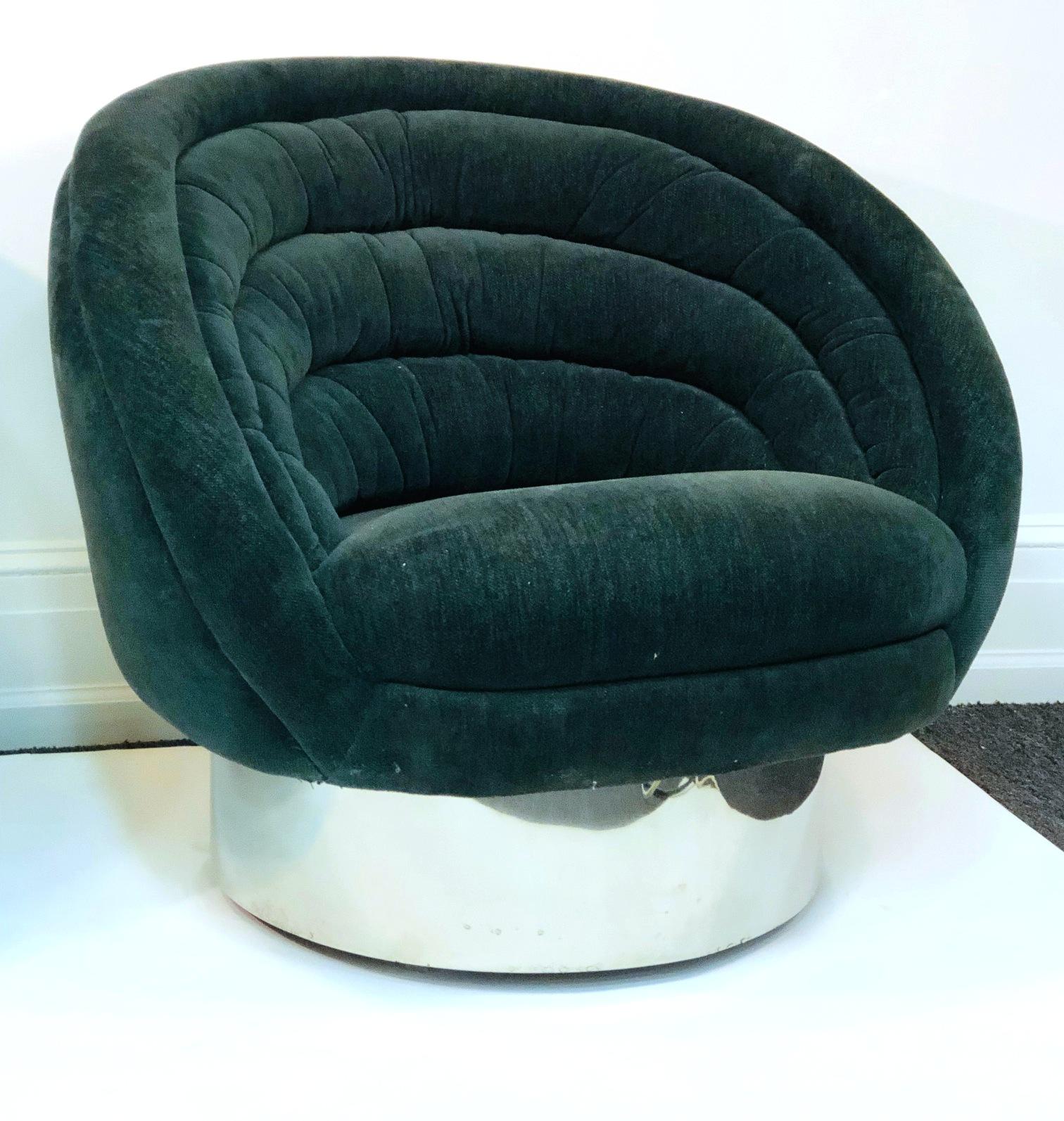 Modern pair of lounge chairs designed by Vladimir Kagan during the 1970s. The pair has circular steel bases and lush upholstered seats. Original label on the bottom. The pair is in good vintage condition with some age-appropriate wear.