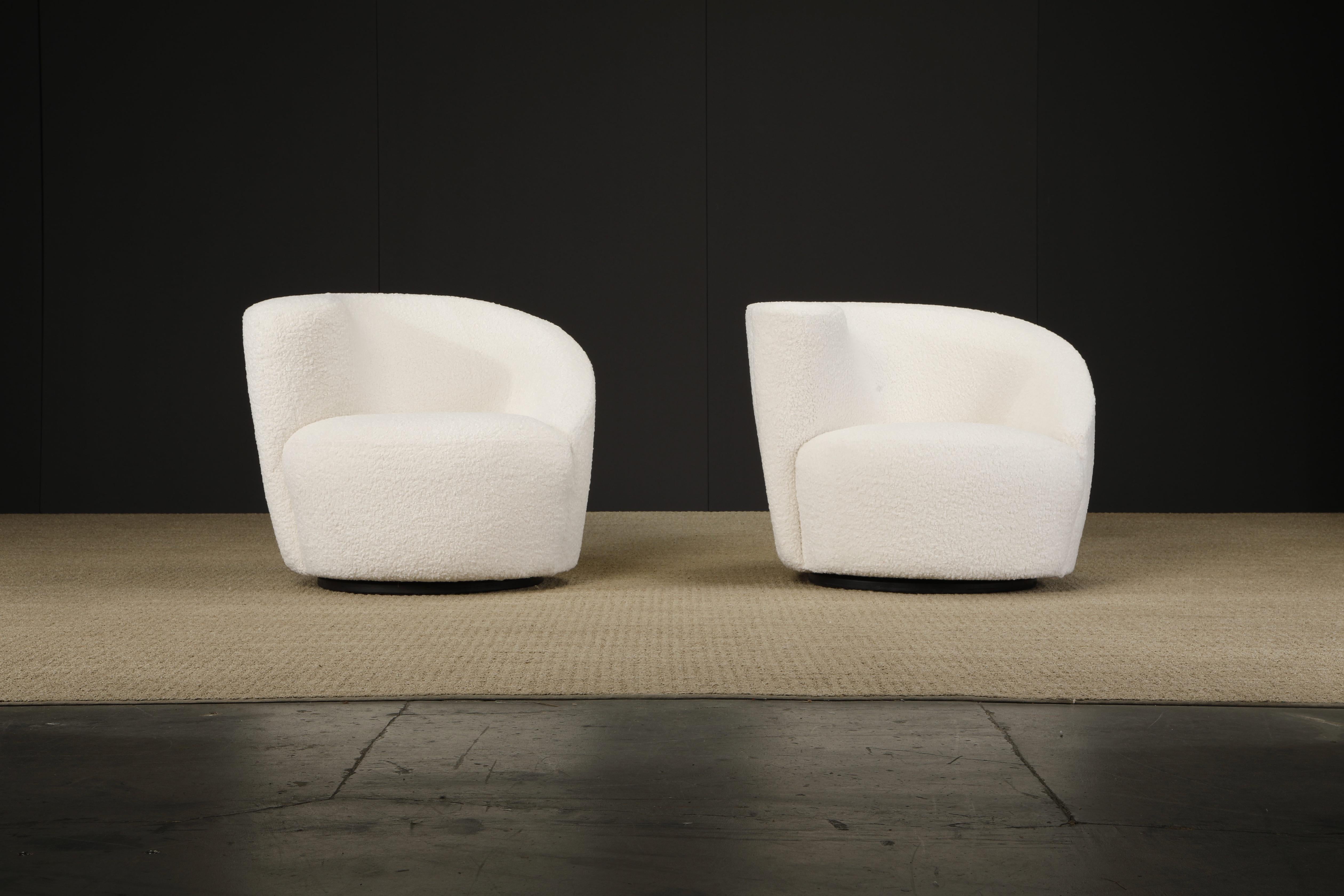 Newly reupholstered in a soft and nubby white bouclé, this pair of 'Corkscrew' swivel chairs by Vladimir Kagan for Directional, circa 1980 are signed with a Directional labels underneath. These classic club chairs swivels 180 degrees on a black